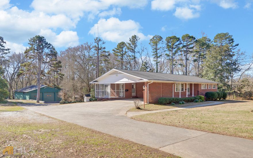 Brick home on 14 acres in the city limits of Hartwell. With approximately 3500 SF, the home has a separate dining room, formal living room, den with gas logs in the fireplace, kitchen, 3 bedrooms, 2 full baths and one half bath on the main floor. The full, finished basement has a second kitchen and full bath. Appliances included are a stove, refrigerator, dishwasher, washer & dryer. Screened-in porch, covered patio, and fenced-in back yard. Oversized garages, multiple carports, and outbuildings on the property. City utilities include gas (heat & water heater), water, sewage and trash pickup. This great property is priced to sell fast!