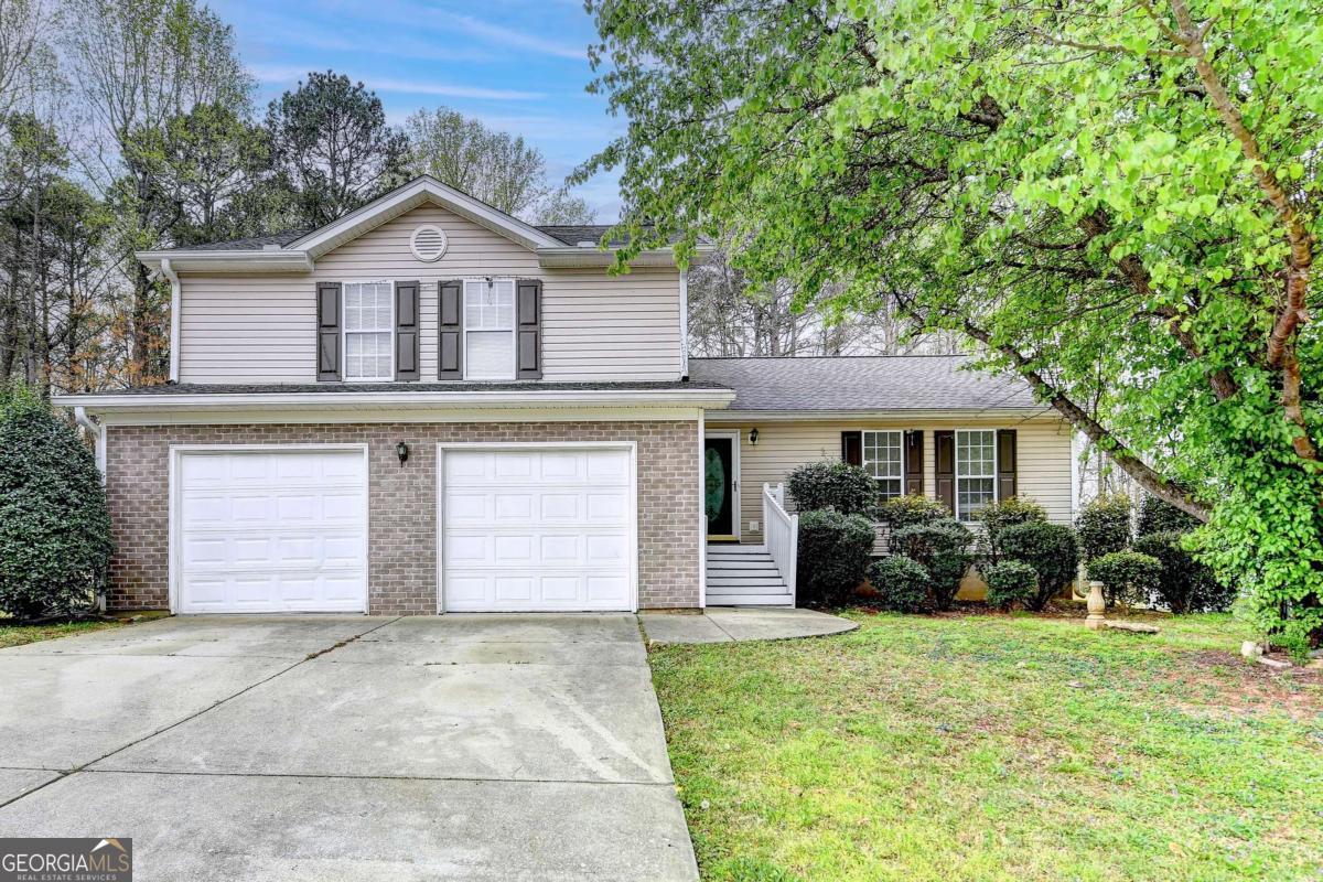 This exceptional property offers a spacious layout, perfect for growing families. Boasting five generously sized bedrooms and three full bathrooms, this home features beautiful hardwood floors, an open-concept floorplan, and plenty of natural light throughout. The private backyard provides an ideal space for relaxation and outdoor activities. Located in a sought-after neighborhood, this home is a rare opportunity to enjoy both comfort and privacy in one of Sugar Hill's most desirable areas. Don't miss out on this incredible chance to make this your home!