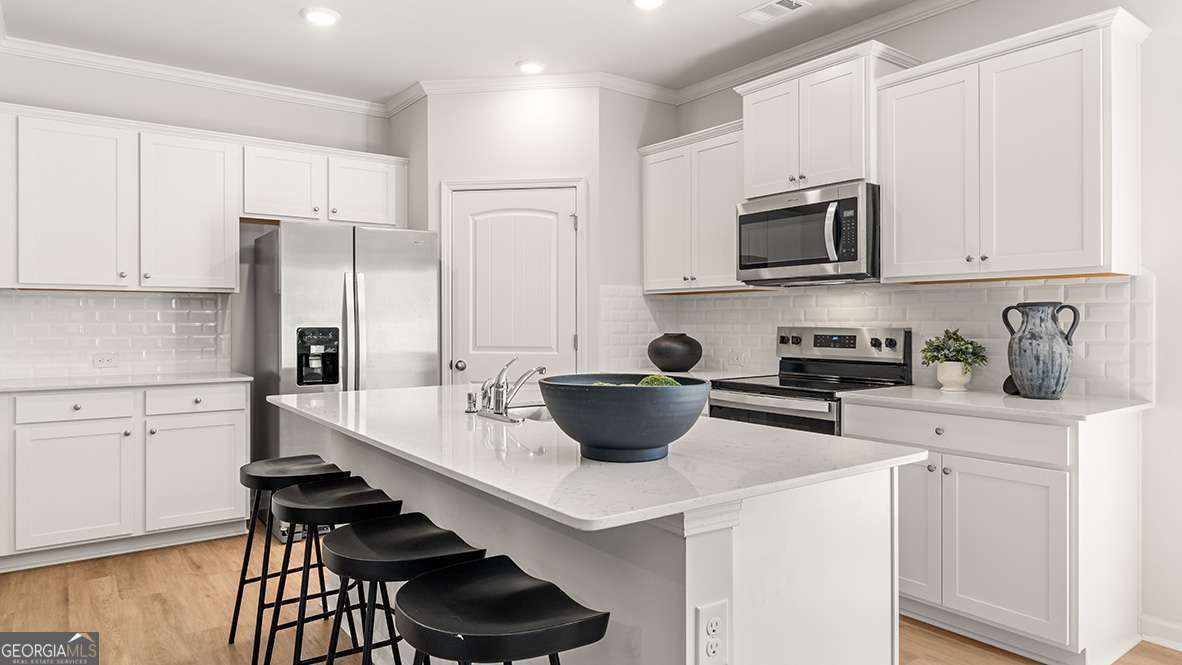 The Sudbury floor plan is a beautifully designed new construction townhome that offers the perfect blend of style, space, and functionality. This two-story home features three bedrooms, two and a half bathrooms, a versatile loft, and a two-car garage. The open-concept main level showcases a modern kitchen with 42 inch cabinets, crown molding, a sleek tile backsplash, and elegant quartz countertops that flow seamlessly into the living and dining areas, creating a warm and inviting space for everyday living or entertaining. Upstairs, the primary suite provides a private retreat with an en-suite bath and a generous walk-in closet, while the secondary bedrooms offer flexibility for guests, family, or a home office. The central loft adds even more versatility, making it ideal for a media room, play space, or dedicated workspace. With modern finishes throughout, ample storage, and a low-maintenance exterior, this home delivers comfort and convenience in a prime Barrett Parkway location close to parks, shopping, and dining.