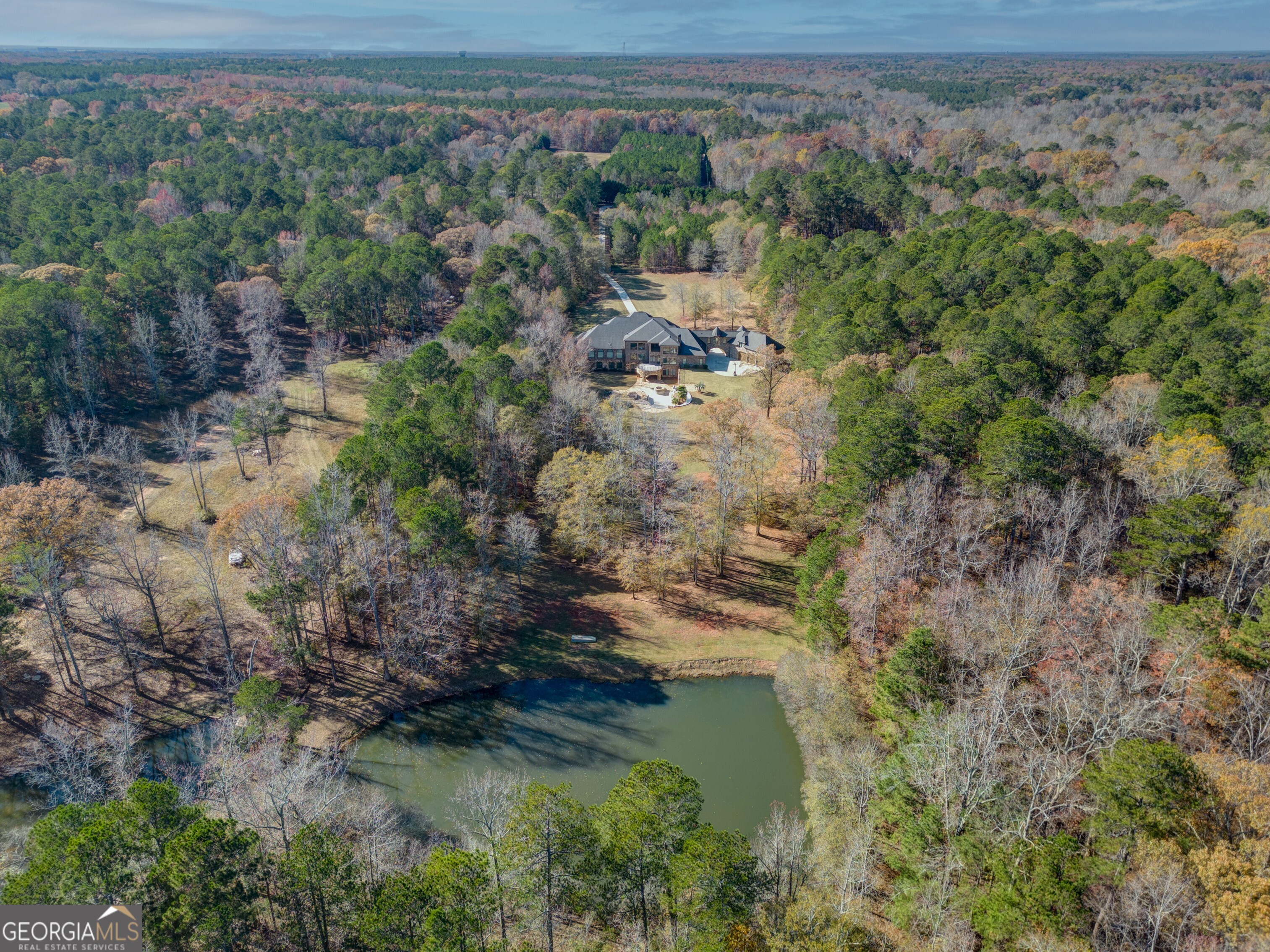 With luxury in every detail, this incredible Henry County estate offers something for everyone. The nearly 12-acre property offers a long driveway back to the privately situated home. The resort-style pool area is offers both luxury and fun with a water slide that runs from a smaller top-level pool down to the large pool below. Past the dog kennels, you'll reach the fully stocked fishing pond at the back of the fully fenced property. The interior of this impressive mansion will truly take your breath away. Soaring ceilings, painted domes, intricate molding, and high-end finishes guarantee a you'll always feel that you are living a life of luxury. The chef's kitchen has everything you could need to make meals for gatherings of any size. The master suite on the main floor has massive windows and its own balcony looking out towards the lake. The full basement has more amenities than you can count, including a second kitchen, fitness room, 360-degree bar, theatre room, wine storage, and an unfinished area set for full size bowling lanes! Come see this one-of-a-kind Henry County mansion for yourself.