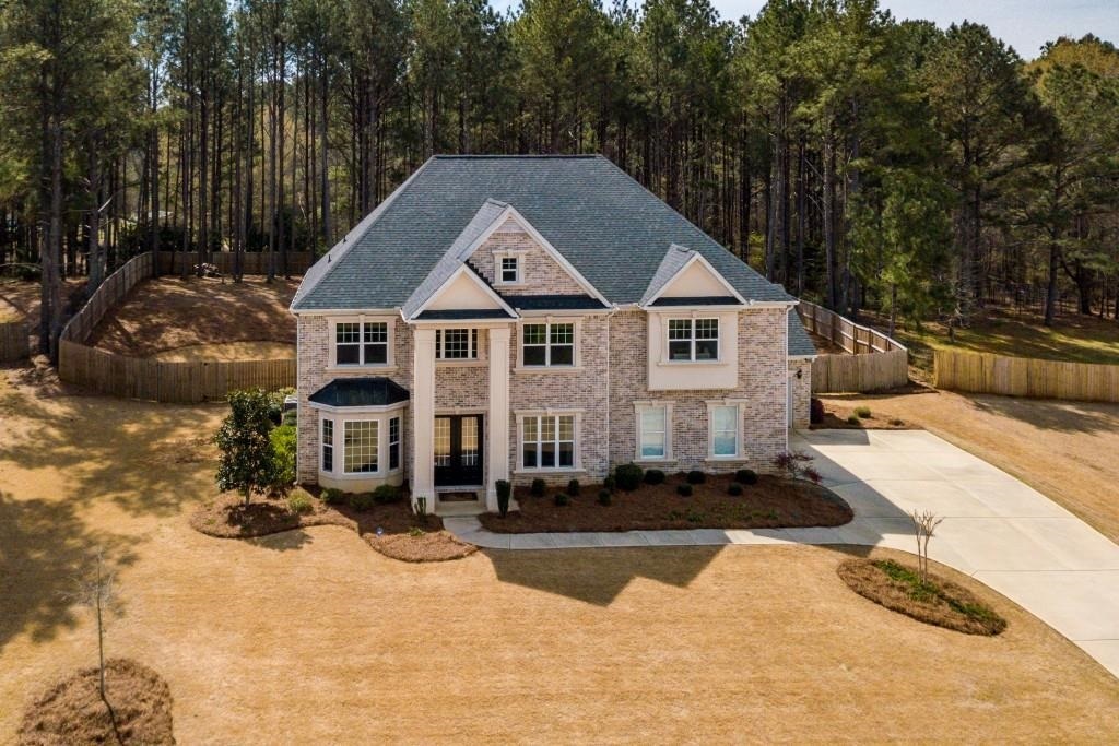 Wow! Large all brick estate with over 4600 sq ft. with tons of natural light and space for entertaining. Hardwoods throughout with w/ gourmet kitchen and island. Main level has a in law suite with a spacious bathroom. Upstairs the master bedroom is huge with sitting area and master closet has a connection to laundry room. Master bedroom also has vaulted ceiling with his/hers vanities. The backyard is fenced for privacy so plenty room for the kids or pets to run around. Did I mention the 3 car side entry garage?