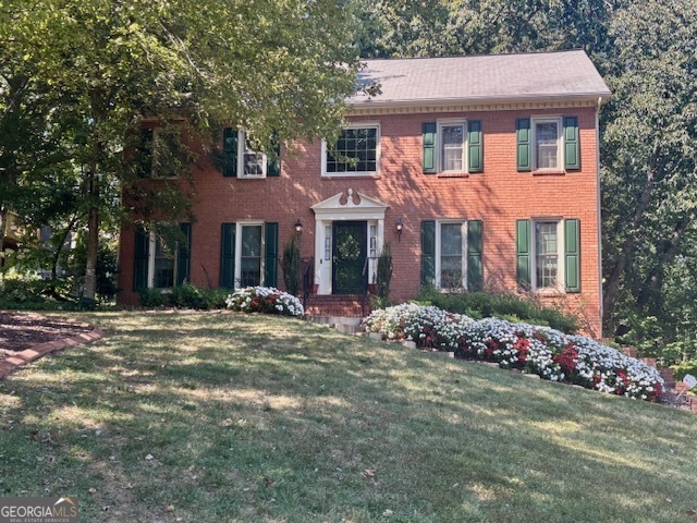 Welcome to this beautiful 2-story traditional brick-front home located in a highly desirable East Cobb neighborhood with an optional HOA of just $85/year. Conveniently situated near I-75, this home offers easy access to top-rated schools, shopping, and dining. Step inside to discover a warm and inviting family room featuring custom solid wood judge's paneling, seamlessly connected to a formal living room (perfect for a home office) and a formal dining room-ideal for entertaining. The kitchen offers stained cabinetry, a tile backsplash, and solid surface countertops for both style and functionality. Upstairs, the spacious owner's suite includes a large walk-in closet, garden tub, and a separate shower. Three additional bedrooms and a full bath provide plenty of space for family or guests. There is also a laundry shoot conveniently located upstairs! The basement includes a large storage area and a spacious 2-car garage, perfect for organization and convenience. Step outside onto the back deck(s) and enjoy a serene, wooded private lot complete with a charming double swing-perfect for relaxing or hosting gatherings. Don't miss this opportunity to own a well-maintained home in a sought-after East Cobb location!