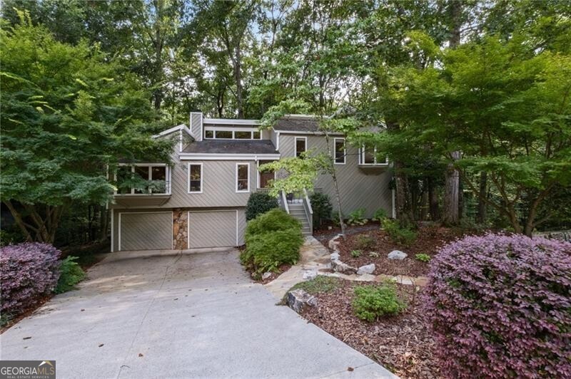 Updated East Cobb Home on Cul-de-Sac in Pope High School District - Over Half an Acre! Located in a highly sought-after East Cobb community, this beautifully updated 3-bedroom, 3-bath home plus finished bonus room sits on a quiet cul-de-sac and over half an acre of private, wooded land. Inside, you'll find a spacious fireside family room with vaulted ceilings, exposed wood beams, floor-to-ceiling stone fireplace, and hardwood floors throughout the main level. The kitchen is updated with custom cabinets, under-cabinet lighting, and stainless steel appliances-perfect for daily living and entertaining. Primary and secondary bathrooms have been stylishly renovated. The finished terrace level includes a flexible space ideal for a home office, recreation room, or additional bedroom. Enjoy outdoor living with a large extended deck and lower patio-ideal for relaxing or hosting guests. Surrounded by mature trees and natural beauty, this home offers privacy, space, and convenience. Zoned for top-rated Pope High School, with easy access to shopping, dining, and major highways-this is East Cobb living at its best.
