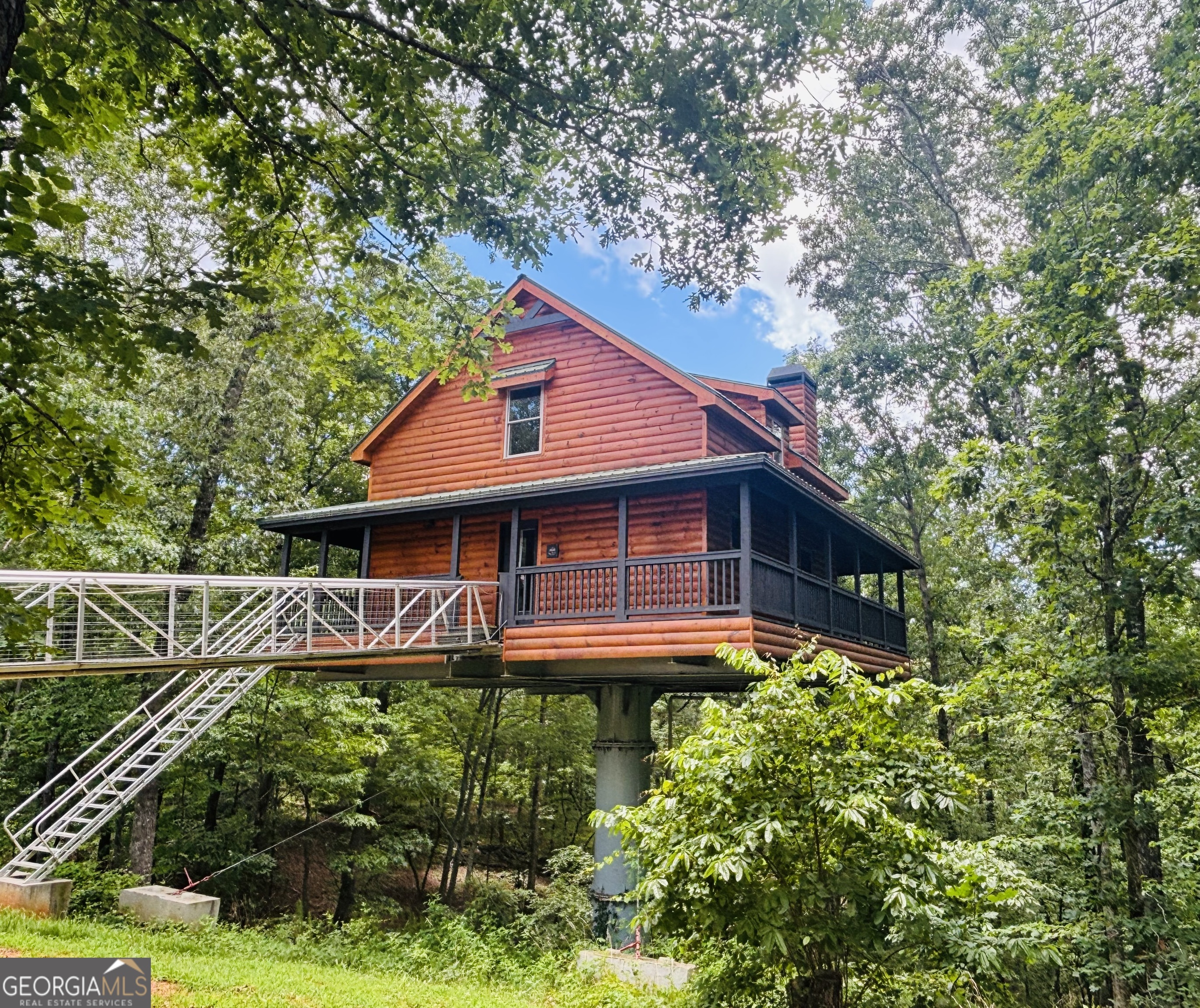 Escape to the ultra unique mountain retreat, "The Sky's The Limit!"! This luxurious treehouse cabin, perfect for short-term rental or your very own private retreat! It boasts a spacious wrap-around porch with a hot tub where you will feel like you really are in the treetops, creating the ultimate relaxation destination. Inside, an open-plan living area with a cozy fireplace flows seamlessly into the bedroom, complemented by an indoor hot tub, large shower, and sauna for a truly indulgent experience. The kitchen features granite countertops and everything you need for a memorable getaway. Upstairs, a loft provides a game room and additional sleeping space on a comfortable futon. Enjoy a private fire pit, and easy access to local wineries, hiking trails, and shopping. This super unique, private luxury cabin offers an unforgettable mountain escape and comes fully furnished... The Sky really is the Limit so call today to see for yourself!