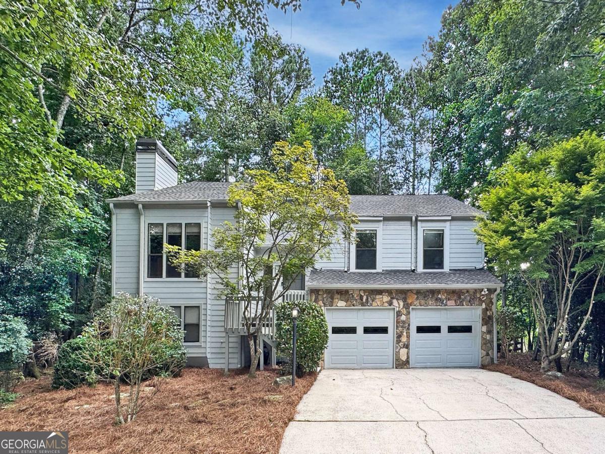 A great place to call home! Don't miss this unique 4 bed, 3 bath split-level home nestled on a quiet cul-de-sac in the Alpharetta swim/tennis community of Haynes Landing! This home has been lovingly maintained by its owner of 30 years! Vaulted ceilings throughout the main level make every room feel even more spacious! The main level includes a fireside family room, formal dining room, renovated kitchen complete with vaulted wood plank ceiling, custom cabinetry, stainless appliances, convenient secondary prep sink, and adjacent breakfast area! Additionally on the main level, you'll find two sizable guest bedrooms, shared guest bathroom, and the oversized primary bedroom with spacious ensuite bath including a double vanity, jetted tub and separate shower. The finished walkout daylight terrace level includes an additional guest bedroom, updated full bathroom, large multi-purpose spaces, office/flex room, and laundry room. Outside, you can enjoy grilling out or just lounging on the main level deck overlooking the large fenced-in wooded backyard, or relax in the shade on the lower patio with under decking for convenient rain or shine use! Hardiplank siding! New carpet! Haynes Landing offers residents access to a large pool and clubhouse, playground, and well-maintained tennis courts, with the added convenience of being a short stroll away from three shopping centers, including Kroger, Publix, and Fresh Market, as well as Johns Creek's nearby Newtown Park! Don't miss out on this opportunity to make this one-of-a-kind residence your new home sweet home!