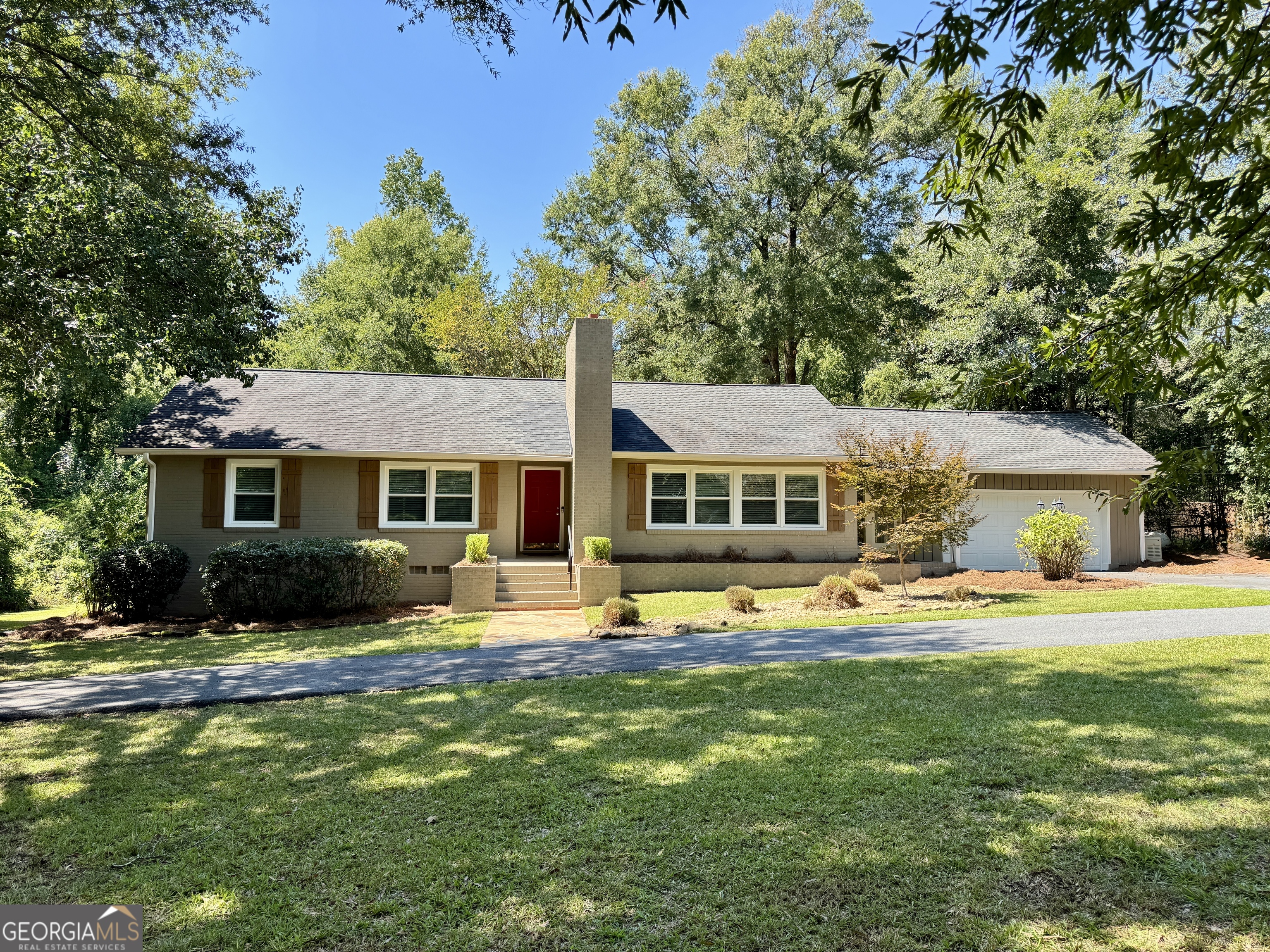One level, 4BR all brick home at a fabulous price in North Macon, with nearly 1.6 Acres! Take a nice walk to the serene rainwater creek through a private trail in the backyard. Enjoy a fresh Mandarin Orange from the Fruit bearing Satsuma tree. Updated kitchen and bathrooms, spacious living areas, and a workshop area in the garage, with plenty of storage throughout. Generac power supply, tankless water heater and new windows assist well with energy costs. Price reflects cosmetic updates such as paint and flooring. Take a look today! This property is a dream.