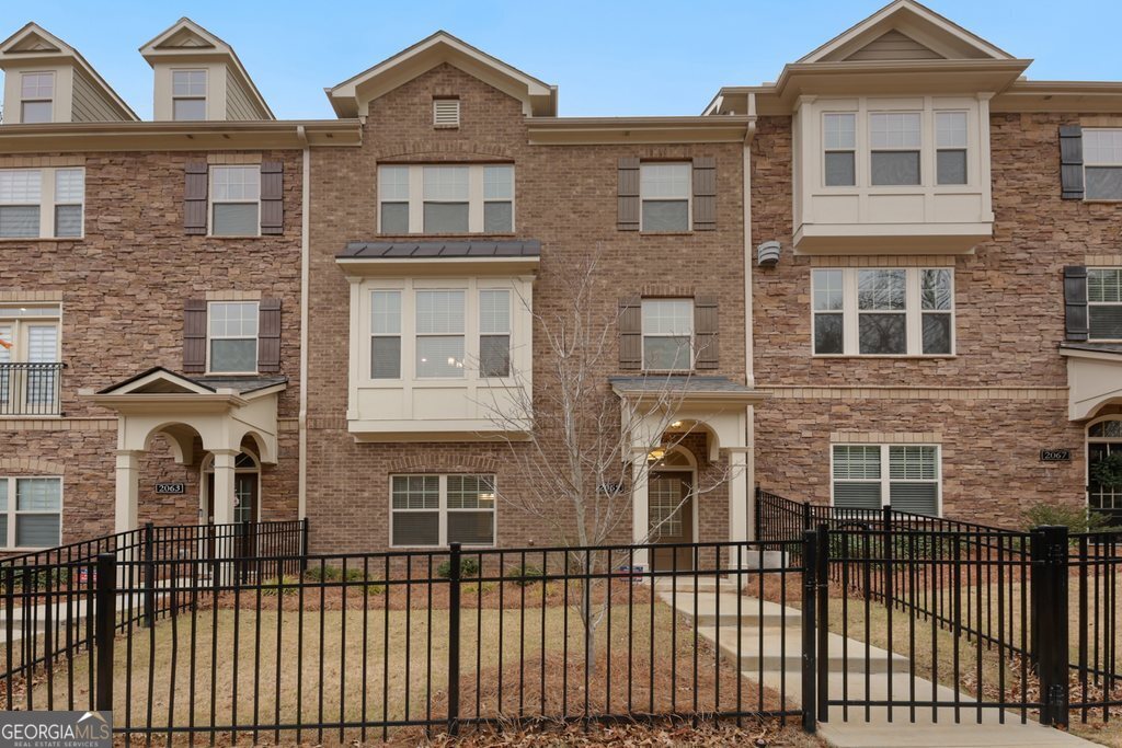 Welcome to your dream home in the highly sought-after Evins Walk! Built in 2020, this exquisite townhome offers modern luxury, convenience, and an unbeatable location. Step inside to discover a gorgeous kitchen featuring a large island, sleek quartz countertops, ample cabinet space, and a spacious walk-in pantry. The open-concept living room is bathed in natural light, boasts a cozy gas fireplace, and provides direct access to your private deck, ideal for relaxing or entertaining. Upstairs, you'll find the large primary bedroom with an en-suite bathroom featuring an oversized shower and a walk-in closet with plenty of storage. Two additional bedrooms and a full bathroom complete the upper level. The lower level offers a fourth bedroom with a full bathroom, perfect for guests, a home office, or a private retreat. Enjoy the perks of this gated community, including a sparkling pool and serene courtyard. This townhome features a 2 car garage and a driveway with room for 2 more cars, as well as street parking right in front of your home with pedestrian gates leading you to the front door, convenience is key. Located just minutes from Buckhead, parks, grocery stores, shopping, entertainment, Emory, MARTA, and more, this home offers the best of Brookhaven living. Don't miss out on this incredible opportunity-schedule your showing today!