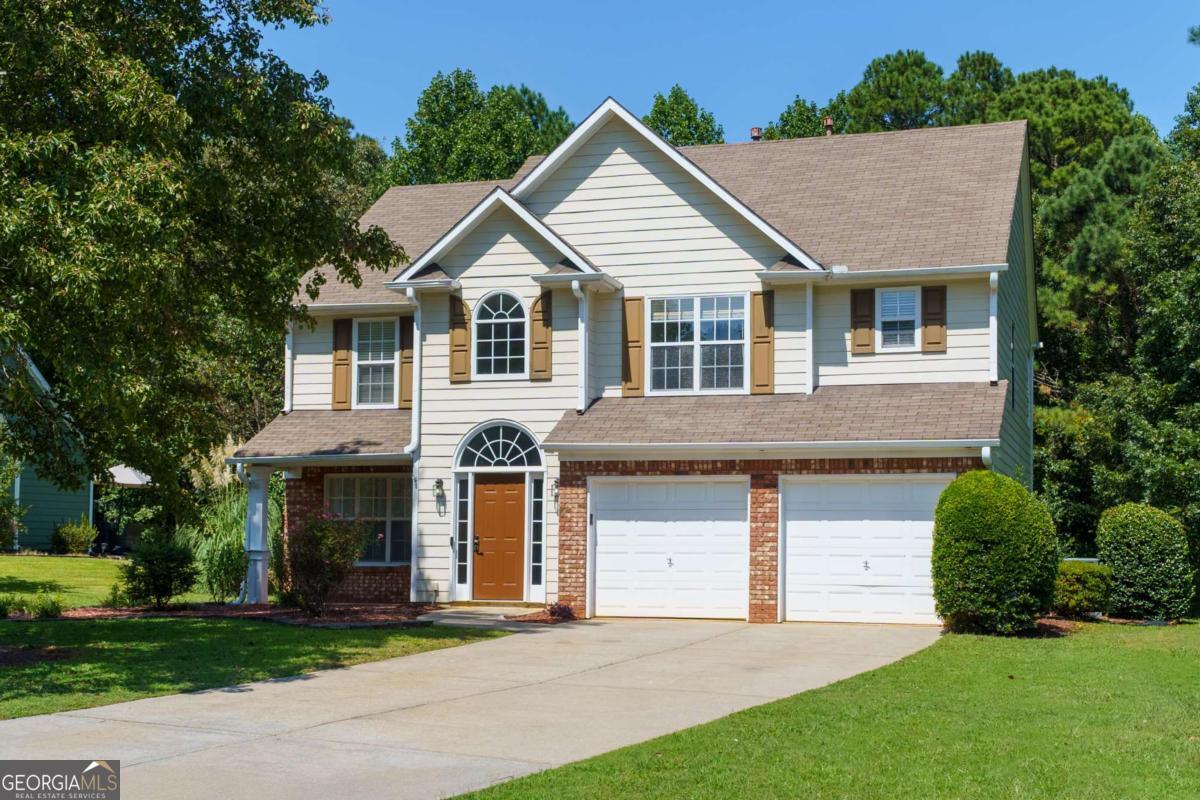 This spacious home sits on 0.67 acres with a beautifully maintained backyard featuring a stunning aboveground pool, expansive deck, and tree lined privacy with NO HOA. This classic home has loads of curb appeal with a huge front yard, extended side yard, and flat driveway leading up to the two car garage. You will enjoy easy to maintain landscaping with established shrubbery and a beautiful shade tree. The front porch is covered and offers a wonderful area to sit and unwind. Enter into the home to find hardwood flooring, high ceilings, and loads of natural light. The two story foyer welcomes you to the well designed layout with a spacious floor plan. Just off the foyer is a large formal dining room perfect for entertaining a crowd as it is just off the kitchen for your convenience. The beautifully updated kitchen features white cabinets, new stainless steel appliances, granite countertops, a center island with bar seating, and a pantry. Just between the kitchen and the formal dining room is a butler's pantry making entertaining a breeze! Or use this spot as a tucked away coffee or dry bar. Just off the kitchen is an open concept casual dining area with a fantastic view into the backyard. Continue on into the huge family room where you will find high ceilings, loads of natural light, and a cozy brick fireplace. Also located on the main is a half bath. Head upstairs to find an open loft perfect for creating a reading nook or play area. Your laundry is also conveniently located on the upper level with all bedrooms and the new washer & dryer are included! The oversized master bedroom features a trey ceiling, updated flooring, TWO walk in closets, and en suite bath with double vanity, soaking tub, and separate shower. The additional two bedrooms are also spacious and share the jack-n-jill style second bath with vanity, updated brass style fixtures, and a shower-tub combo. Enjoy the outdoors where you have an open air back patio just off the family room as well as a huge, tree lined backyard with loads of space for pets, a play area, or garden. Follow the stone pathway to your own personal oasis with a large above ground pool surrounded by a beautiful sundeck. This is such a fantastic spot to relax or entertain friends or family. The property also offers a shed for additional storage of gardening, landscaping, or pool supplies. Located in a highly sought after school district, this home is centrally located near local shopping and restaurants, as well as I-575. Within minutes you can find local coffee shops, Downtown Canton, parks, and the upcoming completed Downtown Holly Springs area that will bring additional community events such as shopping, concerts, and more! The property is in move-in ready condition, with excellent potential for future updates while already offering comfort, style, and functionality.