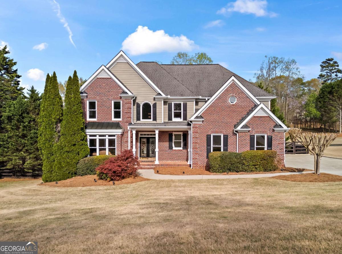 Welcome to 410 Hickory Fairway Ct, a stunning home in the highly sought-after Bradshaw Farm community. Perfectly situated on a cul-de-sac lot with breathtaking fairway views, this home offers luxury, comfort, and unbeatable outdoor living. The backyard is an entertainerCOs dream with a custom pool and spa, a screened-in porch, and an outdoor fireplace, all surrounded by professional landscaping. Inside, the enormous vaulted primary suite feels like a retreat, featuring a spa-like bathroom with marble wall tile, a freestanding tub with a tub filler, a custom glass shower, and brand-new vanities, countertops, mirrors, and lighting. The gourmet kitchen boasts a brand-new Bosch five-burner gas stove, sleek new countertops, and a designer backsplash. Flex room on main that can serve as an office, bedroom, playroom, etc. A fully finished basement with an in-law suite provides extra space for guests or additional living areas. Throughout the home, you'll find new closet shelving, upgraded outlets, and fresh hardware, blending modern updates with classic charm. Located in a top-rated school district with access to golf, swimming, and tennis amenities, this home offers an incredible lifestyle in one of WoodstockCOs most desirable neighborhoods. Don't miss the chance to make it yours. Showings will begin Sat, 4/12. Preferred lender incentives available.