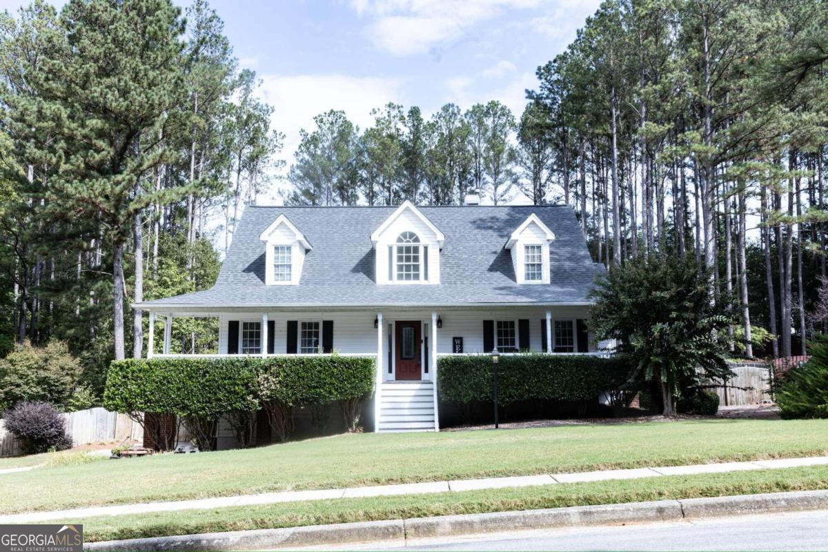 Welcome home to this charming Southern retreat, featuring a picturesque wraparound rocking chair porch, perfect for morning coffee or evening relaxation. Step inside to the fireside great room, offering a cozy ambiance & an open view to the chefCOs kitchen, with sleek granite countertops, updated cabinetry, & SS appliances. The bright breakfast area is ideal for casual meals, while the formal dining room provides plenty of space for hosting! Enjoy the natural light pouring into the sunroom, which opens onto an expansive, custom built deck overlooking a private, fenced backyard, perfect for outdoor entertaining or serene relaxation. The spacious master suite on the main level boasts a luxurious spa-like bath with a soaking tub, double vanities, and a separate shower. Upstairs, youCOll find two generous bedrooms & a newly updated bath with a modern tub/shower insert. With fresh designer carpet upstairs, beautiful hardwood floors on the main level, & a brand-new roof, this home blends style & comfort seamlessly!