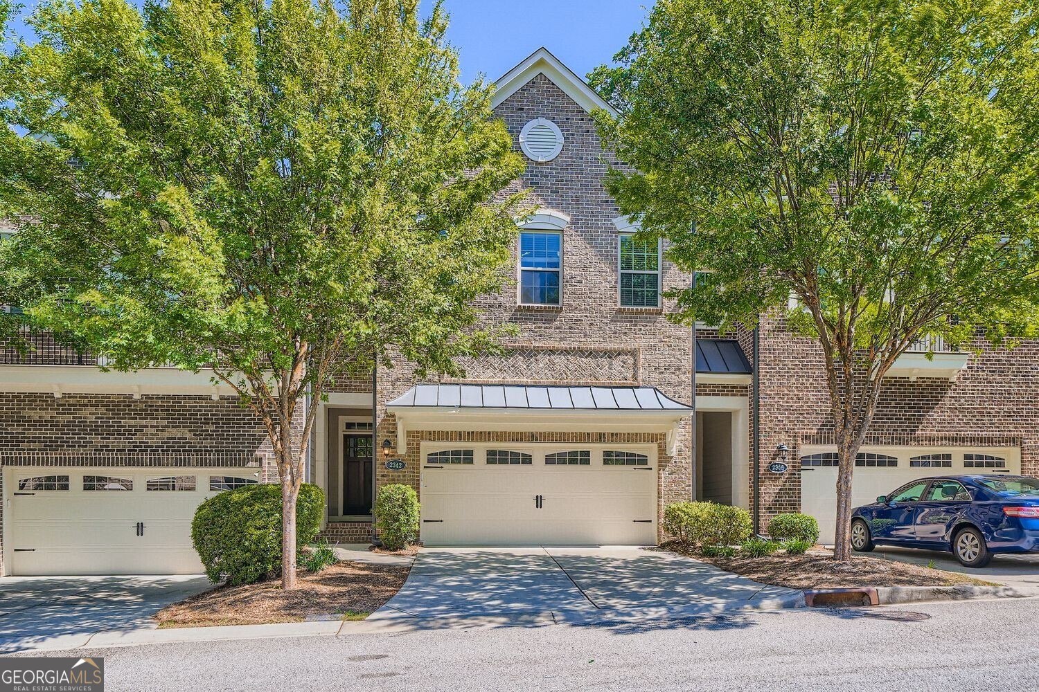 ***Limited-Time Offer***Lease by October 1, 2025, and enjoy $500 OFF your first month's rent! Don't miss out on this incredible opportunity to secure your new home and save big! Welcome home to this stunning, designer townhome perfectly situated in the highly sought-after gated community of Towns at Breton Ridge. Located within walking distance to The Battery Atlanta and Truist Park, this residence offers the ideal blend of luxury, privacy, and convenience in the heart of Smyrna's most desirable location. Nestled on a quiet street with serene, wooded views, this breathtaking townhome boasts an open-concept floor plan filled with natural light. From the moment you step inside, you're greeted by gorgeous hardwood floors, soaring 10-foot ceilings, custom crown molding, a designer brick accent wall, and a show-stopping fireplace a true entertainer's dream. The chef's kitchen is a masterpiece, featuring custom cabinetry, quartz countertops, stainless steel appliances, and an oversized island that doubles as the perfect gathering spot. An inviting eat-in breakfast area overlooks the private terrace, where you can unwind and enjoy undisturbed forest views and breathtaking sunsets. Upstairs, a spacious loft area provides versatility ideal for a home office or cozy lounge. The luxurious owner's suite is a retreat of its own, complete with a walk-in closet and a spa-inspired bath boasting an oversized dual-head shower with frameless glass, dual quartz vanities, and a linen closet. Two additional generously sized bedrooms share a beautifully appointed full bath, and the walk-in laundry room complete with washer and dryer and excellent storage and convenience. The finished terrace level is equally impressive, featuring 9-foot ceilings, and a private guest suite with its own walk-in closet and a luxury full bath perfect for hosting family and friends. Step outside to the covered patio to unwind and take in some fresh air. This home truly has it all elegant design, modern finishes, privacy, and unbeatable location.
