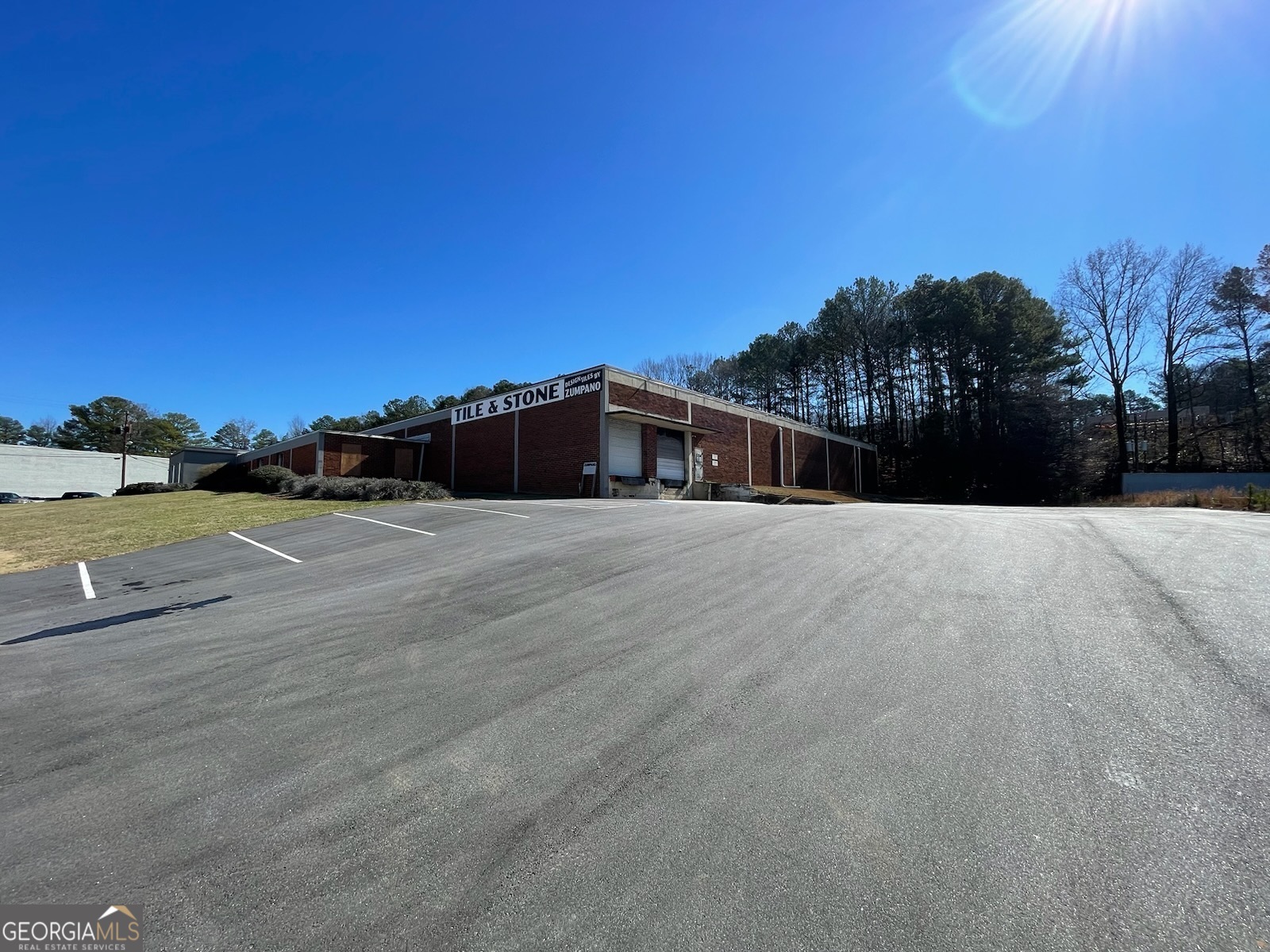 New Industrial Listing! 38,400+ SF Warehouse | $6M  An exceptional opportunity to acquire a highly functional  industrial facility in Norcross, GA, strategically positioned  near I-85 & Jimmy Carter Blvd. This 38,400+ SF warehouse  on 2.54 acres is currently operating as a builder's product  distribution hub, featuring an expansive showroom,  reception area, multiple executive offices, production and  sales offices, supervisor offices, a sample room, and four  restrooms. The Seller prefers a "Leaseback" Agreement,  offering investors an attractive immediate income  opportunity!  This turnkey facility boasts a new $100K roof, 18' clear  heights, mezzanine space, and offices, along with three  dock-high loading bays, two ramp drive-in bays, and one  drive-in bay with dock-high access. The property also  includes an 800 SF three-bay storage building, 30+ parking  spaces, dual entrances, and newly resurfaced parking lots.  Adding to its value, the sale includes forklifts, delivery vans,  a Ford F-750 Diesel 20' flatbed truck, and 135+ heavy-duty 12'  high shelving racks. Located in a well-established industrial  park with high-visibility frontage along the I-85 access road,  this property benefits from its proximity to restaurants,  hotels, and retail centers, making it an ideal investment or  owner-user acquisition.    **This is a confidential listing! Showings are by appointment  only and require pre-screening and financial qualification.  DO NOT DISTURB current business operations, staff, or  ownership.** Contact the Brokers today to discuss this  exceptional industrial asset! Call Fielding at 770.862.4133 or  Sonia at 404.617.1910