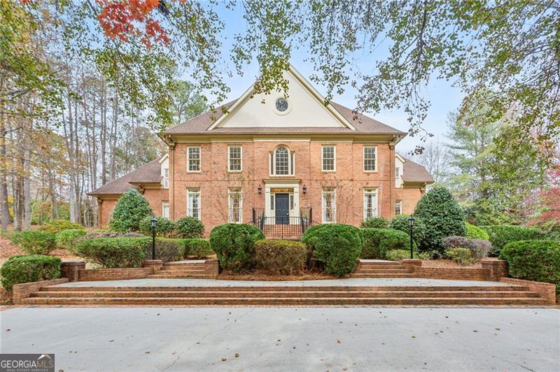 RARE OPPORTUNITY TO OWN A CUSTOM MASTERPIECE IN HISTORIC DOWNTOWN MARIETTA ON 1.5 ACRES! Walk to popular Marietta Square with all its fabulous restaurants and exciting happenings, Kennesaw Mountain Battlefield Park & miles of hiking Trails, close to Kennestone Hospital & Medical Multiplex. Award winning West Side Elementary and Marietta City Schools also close to private schools Walker and Mt.Paran. Magnificent BRICK estate with circular drive has 3 car side entry garage w/unfinished space above has enormous potential. Primary suite on main, fireside library, office, banquet dining room, 2 story great room has stunning paneling/cabinetry by Krogh Built. 2 powder rooms on main. Wonderfully large open kitchen has huge island and flows into great room, breakfast area and sunroom with walls of windows and high ceilings. 4 oversized guest rooms upstairs has two TRUE jack and Jill style tiled baths each with loads of storage closets. Full, finished daylight terrace level boasts an inviting wood sauna, another bedroom, full bath, more storage and easy access to systems. Extra room is ideal for media room if desired. Charming features such as an English Boxwood garden, bluestone and brick patio, covered walkway from garage all add to the sophistication of this special home. Mature, Established landscaping. Space is available to have a pool and pool house if interested. No detail spared in this thoughtfully planned floorpan with classic character. Make this home your own with your personalized intentional updates and truly have a property that is unmatched in the area! A residence of this size and caliber could not be duplicated in todays market for the asking price.