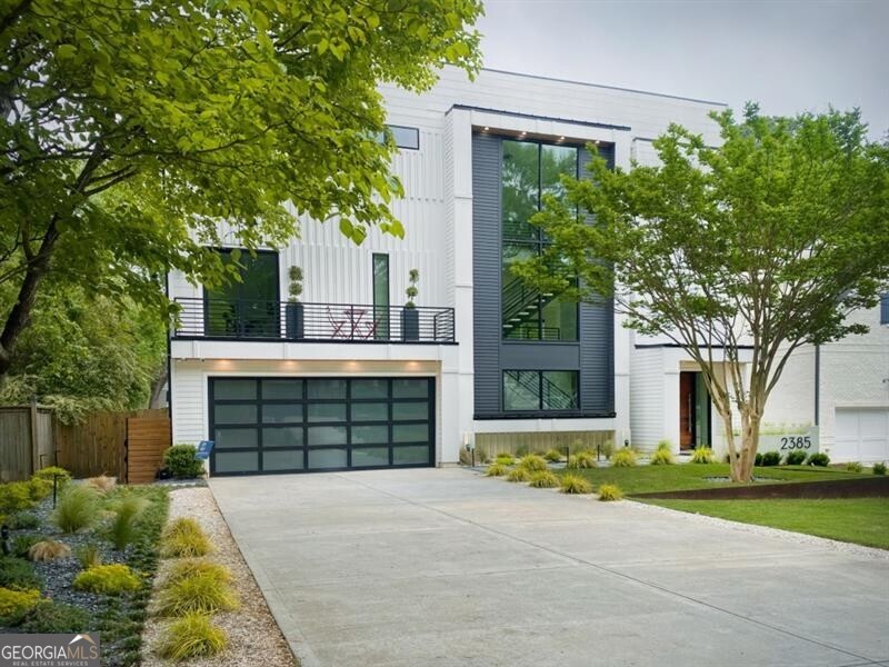 UNSURPASSED CUSTOM-BUILT MODERN DESIGNED BY RENOWNED SOUTH AMERICAN ARCHITECT ANDRES GARCIA, THIS ONE-OF-A-KIND MODERN RESIDENCE BLENDS STRIKING DESIGN WITH EXCEPTIONAL FUNCTIONALITY. A DRAMATIC FLOATING STAIRCASE AND BREATHTAKING THREE-STORY GLASS WINDOW SET THE TONE FOR THE HOME'S SOPHISTICATED, LIGHT-FILLED INTERIOR. THE MAIN FLOOR WELCOMES YOU WITH A GRACIOUS ENTRY FOYER, PRIVATE GUEST BEDROOM WITH FULL BATH, AND A STYLISH FAMILY ROOM OUTFITTED WITH A BUILT-IN WET BAR, WINE, AND BEVERAGE COOLERS. THE SPACE FLOWS SEAMLESSLY TO A COVERED PATIO FEATURING A NEWLY COMPLETED OUTDOOR KITCHEN OVERLOOKING A BEAUTIFULLY FLAT, FENCED AND POOL-READY BACKYARD. THIS LEVEL ALSO INCLUDES AN OVERSIZED TWO-CAR GARAGE WITH GENEROUS STORAGE. UP ONE LEVEL, SOARING CEILINGS HIGHLIGHT AN OPEN-CONCEPT FIRESIDE GREAT ROOM, BANQUET-SIZED DINING AREA WITH BUILT-INS, AND A CHEF'S KITCHEN EQUIPPED WITH STAINLESS STEEL APPLIANCES, AN OVERSIZED QUARTZ ISLAND, AND A WALK-IN PANTRY. EXPANSIVE CUSTOM SLIDING DOORS CONNECT THE GREAT ROOM AND DINING AREA TO A SPACIOUS DECK PERFECT FOR INDOOR/OUTDOOR GATHERINGS. A CHIC POWDER ROOM, DEDICATED OFFICE WITH CLOSET, AND A SECOND GUEST SUITE WITH FULL BATH COMPLETE THIS FLOOR. THE TOP LEVEL IS HOME TO A SPECTACULAR PRIMARY SUITE FEATURING TWO EXPANSIVE WALK-IN CLOSETS AND A LUXURIOUS SPA-INSPIRED BATH. TWO ADDITIONAL ENSUITE BEDROOMS AND A FULL-SIZE LAUNDRY ROOM ROUND OUT THE UPPER FLOOR.