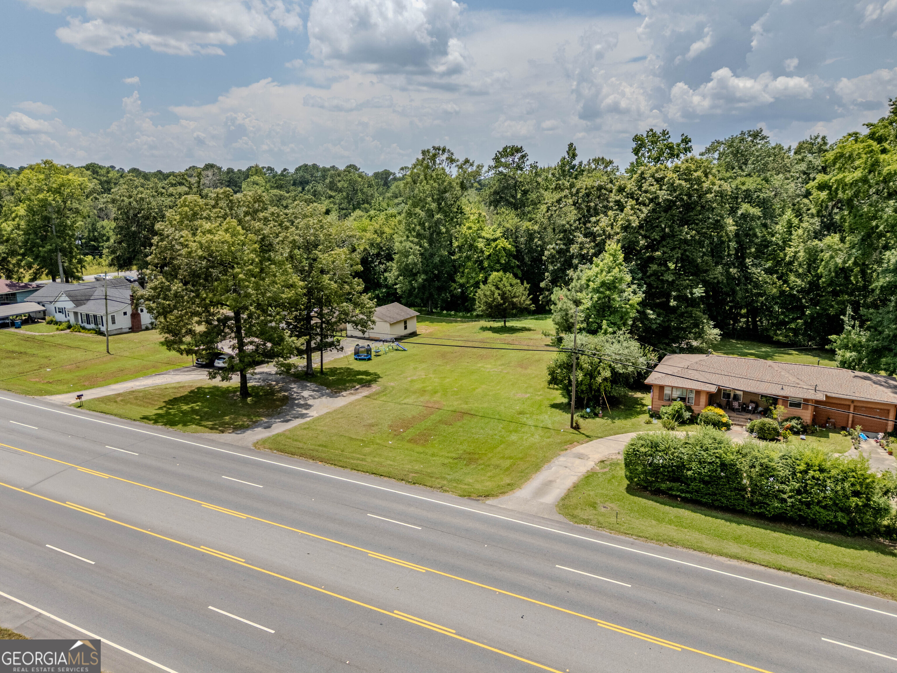 The Property consists of 1.02 acres of land situated on Martha Berry Highway, directly across from Rhinehart Equipment Company, and between street addresses 3569 and 3589 Martha Berry Hwy. According to GPS mapping, the property is approximately 0.5 miles north of the Food Lion at 3365 Martha Berry Highway, within the city limits of Rome, Georgia. The land offers a mix of open and wooded areas, providing natural privacy, buildable space, and versatile topography. The parcel is currently zoned C-C (Community Commercial) under Floyd County zoning regulations, allowing for a wide range of uses including retail, office, service-based businesses, or a live/work hybrid. This property is located within a highly trafficked commercial corridor, offering outstanding visibility, accessibility, and proximity to major educational, recreational, medical, and commercial institutions including: Berry College, Rome Tennis Center at Berry College, Local and regional shopping centers, Elementary, Middle and High schools, Floyd Medical Center and Redmond Hospital