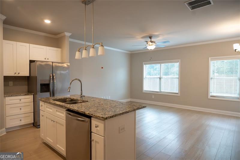 Available now! This like-new 2023-built townhome in the Preserve at Killian Hill offers modern comfort and convenience in the heart of Lilburn. Featuring 3 bedrooms, 2.5 baths, and 1,750 sq ft, this spacious home is designed with an open floor plan perfect for entertaining and everyday living. The main level boasts a bright family room, dining area, and a contemporary kitchen with stainless steel appliances, stone countertops, and ample cabinet space. Upstairs, the owner's suite includes a walk-in closet and spa-style bath with dual vanities, while two additional bedrooms share a full bath. Additional highlights include an attached 2-car garage, central heating & cooling, and low-maintenance living. Located within the highly rated Gwinnett County School District, this home is just minutes from shopping, dining, and major highways for an easy commute. Don't miss the opportunity to lease this move-in ready townhome in a sought-after community. Schedule your tour today!