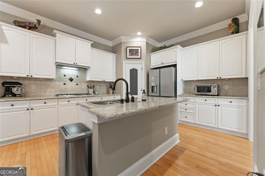 New price and new updated look!!! This gorgeous, three-level ITP end-unit townhome is located inside a quiet gated community at the apex of Chamblee, Brookhaven, and Dunwoody. Open living space on the main floor (middle level) features a fireside living room with built-in shelving and cabinets, a spacious dining room, and large, updated kitchen with stainless appliances, white cabinets, granite counters, and ample storage space. The main level also includes a designer 1/2 bath, sunny deck that spans the back of the home, a coat closet (or butler's pantry - choose your adventure!), and hardwood flooring throughout. On the top level you'll find the oversized primary suite with an enormous walk-in closet (larger than many Manhattan apartments) and a completely renovated, top-of-the-line primary bathroom with a large, trimless shower, decadent soaking tub, and a thoughtful abundance of cabinets and storage. Also on the upper level is an additional bedroom with ample closet space and an ensuite full bath. Completing the top level is a convenient and well-equipped laundry room. The lower level features a large third bedroom with a walk-in closet, a bonus room that can be used as office, playroom, den, guest space, etc., large entryway closet, and full, updated bath. There is a two-car garage attached to the lower level. Please note that all sun-facing windows have been UV filmed to allow for natural light to flood the home without extra heat. The current owners have lovingly updated and maintained this home to make it turnkey for the next owner.