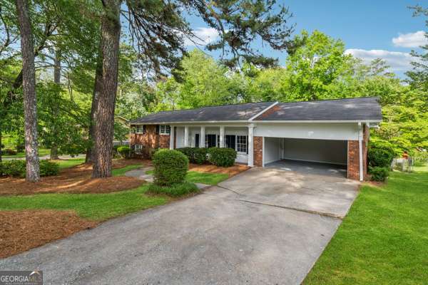 Welcome to this stunning 4-bedroom, 3-bath brick home in the highly sought-after Jamestown Colony neighborhood! Boasting over 3,200 square feet of living space, this beautifully maintained property features professional landscaping, generous parking, and a freshly painted interior with brand new carpet. The spacious layout includes a chef's dream kitchen with stainless steel appliances, granite countertops, and an abundance of cabinets. The living area is anchored by an impressive floor-to-ceiling brick fireplace, perfect for cozy evenings. A large laundry room and a fully finished basement offer even more functionality and space. Step outside to your private backyard oasis-ideal for entertaining-with a large deck overlooking the inviting inground pool, making it the ultimate setting for family gatherings. All this just 2.3 miles from Hartsfield-Jackson Airport and 10 miles from Mercedes-Benz Stadium. Home is sold AS-IS, WHERE-IS. All due diligence must be completed prior to submitting an offer. Closing will be held with Sherman and Phalen Attorney. Buyer to verify all information in listing is accurate as seller never lived in home.