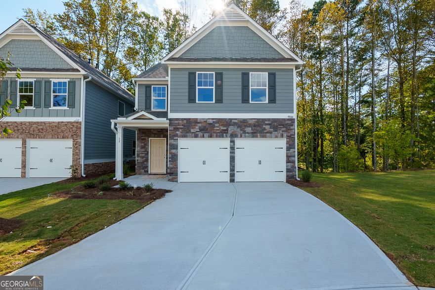 This stunning 4BR, 2.5BA home offers a modern, open-concept design with spacious layout & desirable features. The home boast a grand 2 story foyer.  The heart of the home is the large, chef-inspired kitchen, complete with a generous island, sleek stainless steel dishwasher, gas range, and vent-hood. Granite countertops and ample cabinets. Overlooking family room and D/R, creating an ideal space for entertaining & family gathering. LED lighting adds a contemporary touch to the space along with Luxury Vinyl Plank throughout the first floor.. Upstairs the master suit features a trey ceiling & large walk-in-closet, offering elegance & functionality. Master bath retreat has 42" shower/garden tub, double bowl cultured marble sink, & private water closet. 3 additional secondary B/R's provide plenty of space for family, guest, or an office, while the convenient laundry room & hall bath complete the 2nd level. This home does not include a backyard, it offers a tranquil view of a creek and wooded area behind the property-perfect for relaxing and enjoying nature. Located just minutes from SR 400, the Outlet Mall, and numerous restaurants this home offers both convenience and serenity in a sought-after location.