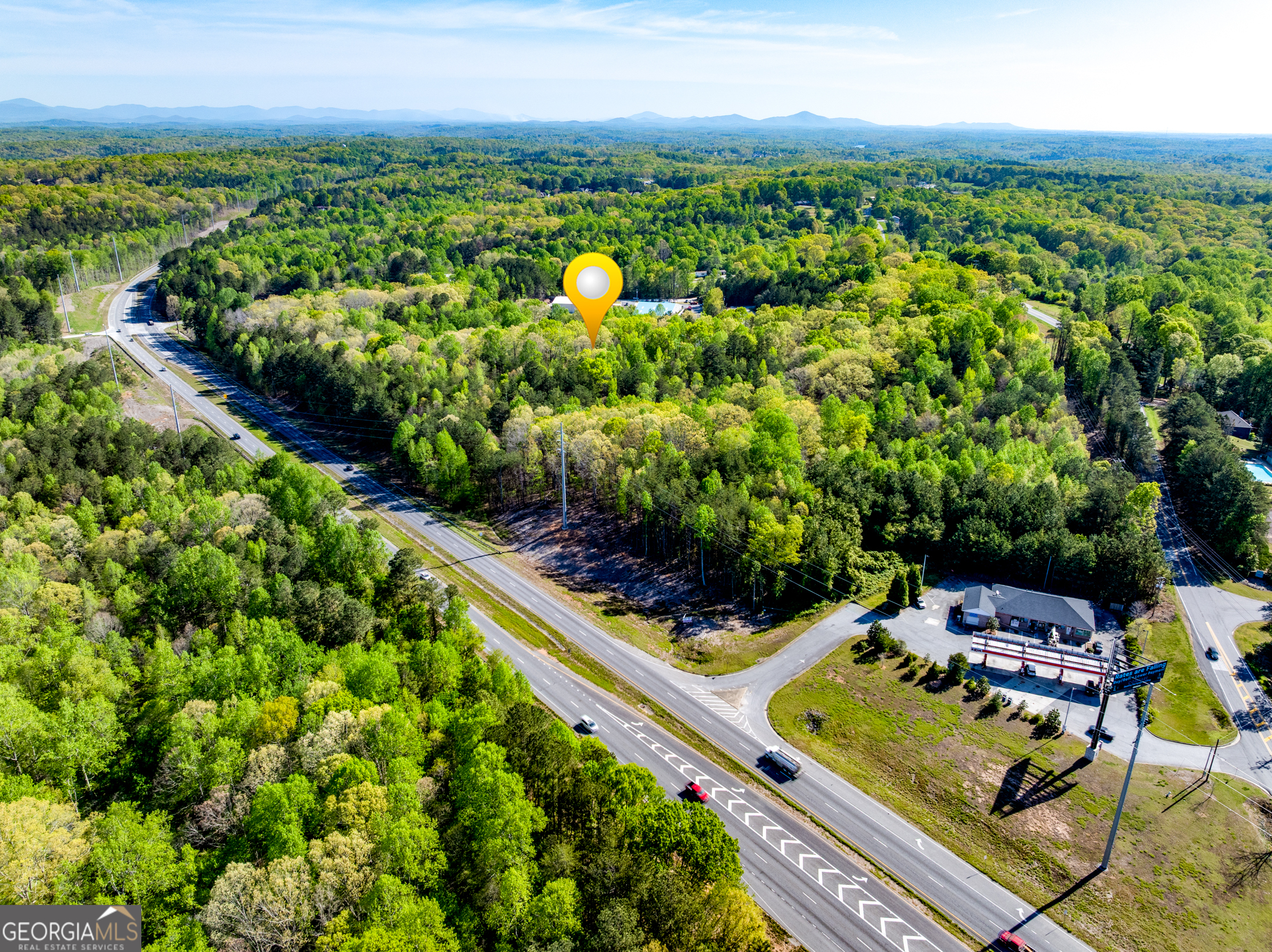 Prime Commercial Land on GA Hwy 400 - 19.45 Acres in Dawsonville, GA Exceptional opportunity to own 19.45 acres of commercially zoned land (C-HB) with incredible visibility and access in one of North Georgia's fastest-growing corridors. This expansive tract features approximately 1,330 feet of road frontage along GA Hwy 400 and an additional 150 feet on Grant Road, offering multiple access points and high development potential. Strategically located just 1.5 miles from the North Georgia Premium Outlets, this property benefits from strong traffic counts, excellent exposure, and proximity to major retailers, restaurants, and residential developments. With its C-HB zoning (Highway Business Commercial), this site is ideal for a wide range of commercial uses including retail, hospitality, automotive, and service-based businesses. Key Features: 19.45 Acres of level to gently rolling terrain Zoned C-HB (Commercial Highway Business) Approx. 1,330' of frontage on GA Hwy 400 Approx. 150' of frontage on Grant Road High-traffic location near major commercial hubs Don't miss this rare chance to secure a premier commercial site with unmatched highway exposure in booming Dawson County.