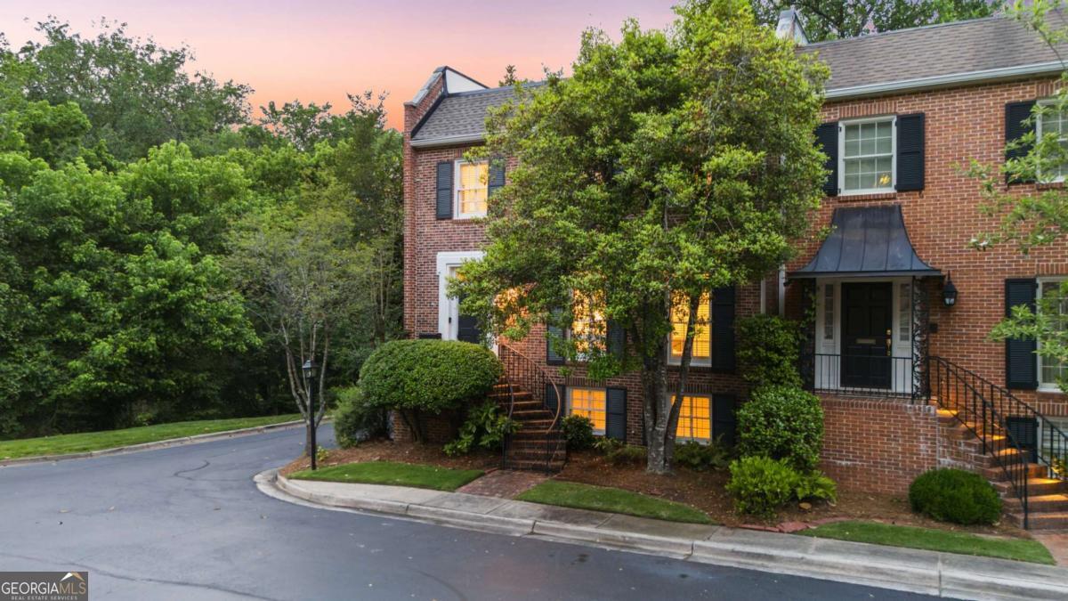 Welcome home to your beautiful, renovated end-unit townhome with your own personal elevator in the prestigious, gated Paces Place community of Buckhead. This residence offers full accessibility with stair-free entry from the garage to the main level and owner's suite via the elevator. Meticulously renovated down to the studs in 2018, the home features an improved layout and high-end interior finishes throughout. Upon entry at the front door, you will enjoy a spacious room that provides versatility for use as an office, music room, or additional sitting area. The main floor is designed for both indoor and outdoor entertaining, including three sets of recently installed French doors leading to a private covered seating area and open balcony overlooking serene natural views. The kitchen is equipped with white Shaker cabinetry to the ceiling, a Stainless-Steel gas range, vent hood, Refrigerator, upgraded granite countertops, subway tile backsplash, and a generous walk-in pantry with custom wood shelving. Real hardwood flooring extends across the main level, staircases, and second floor bedrooms. The ground floor features brand-new LVP flooring- so you will enjoy no carpet in this home. Upstairs, the expansive owner's suite includes new French doors to a private balcony, a newly updated gas fireplace, a large walk-in closet with custom wood shelving, and an elegant bathroom featuring marble tile and countertops. Two additional bedrooms offer ample space, oversized closets, and abundant natural light, with one providing access to a second-floor balcony through French doors. The hallway bath is well-positioned, accompanied by extra storage and a second dedicated laundry room. The ground floor features an oversized bedroom with a walk-in closet and private bath, multiple storage options including two cedar closets and built-ins, as well as a secondary laundry room complete with washer, dryer, sink, and shelving. Recent updates include green drywall installation on this level. The attached two-car garage offers substantial storage, workshop, or gym space. Additional upgrades comprise a new roof (2.5 years old), HVAC systems installed in 2018, exterior paint refreshed in 2023, interior paint in 2025 and a new garage door and system added in December 2024. The exclusive gated community provides amenities such as a pool, sports court, and extensive guest parking, all conveniently located near I-75 and within moments of Buckhead's renowned restaurants, shops, Nancy Creek, and local attractions. Welcome to refined living in Paces Place!