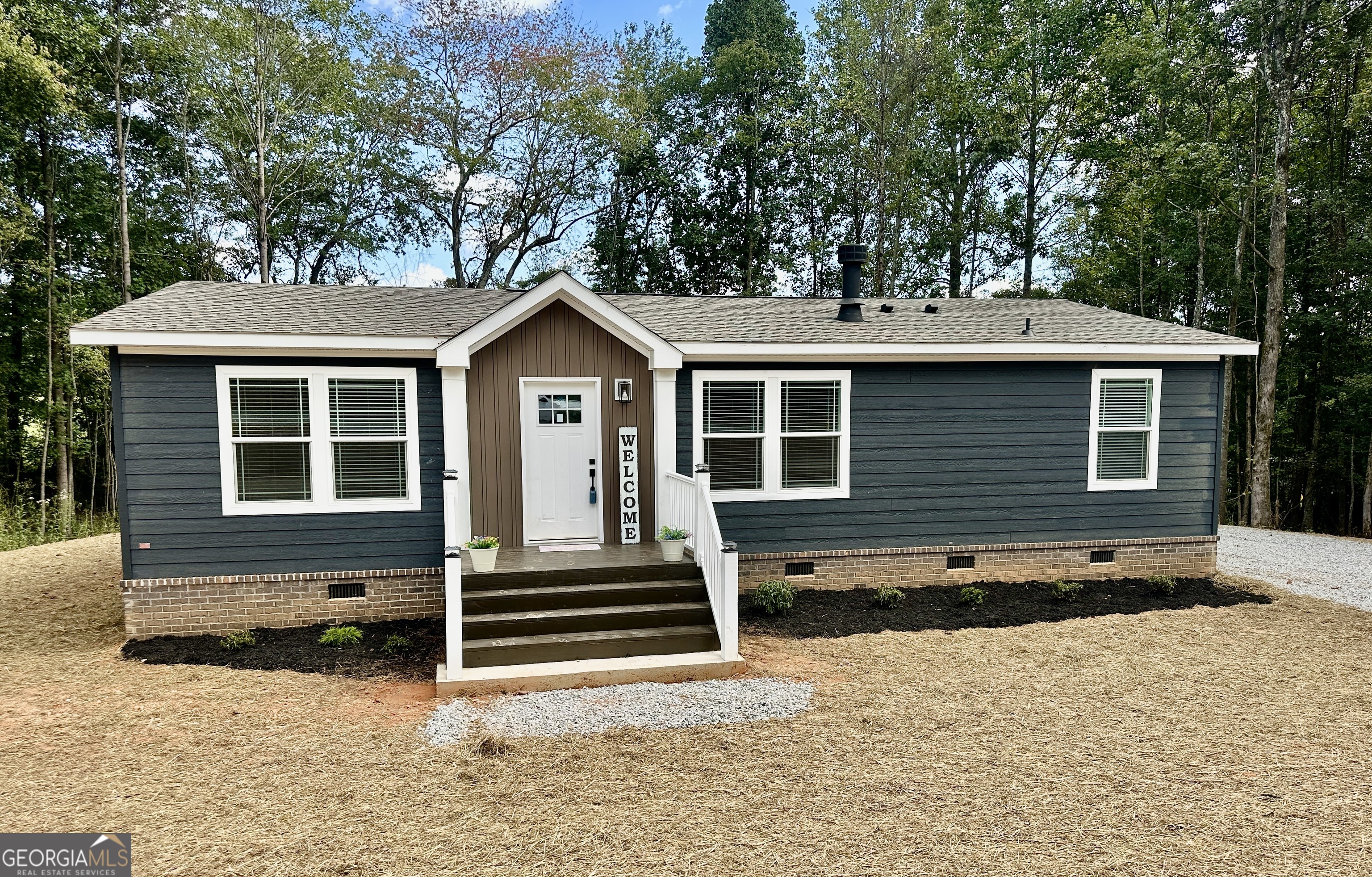 Another unique offering from Progressive Homes (PH); a premier land-home developer of Manufactured Homes in North Georgia- "Where Ordinary becomes Extraordinary. This brand new fully sheet-rocked 3 bedroom, 2 bath home has an open floor plan and a large mud room. The home has LP siding and a wood burning fireplace and beautiful crown molding. It includes an all-brick permanent foundation, a SmartComfort by Carrier heat pump, OSB wrapped exterior, custom stained decks, upgraded insulation, energy efficient windows, stainless-steel appliances, a remote-controlled electric fireplace, a programmable thermostat, and a double sliding door off the dining area leading to a custom-built deck. This house meets the ENERGY STAR (eBuilt) standards meaning its energy efficient with significant savings . The new eBuilt home features: * SmartComfort by Carrier heat pump or gas furnace (required for ENERGY STAR certification) * ENERGY STAR certified appliances * Additional insulation of 22-13-38 * Tight thermal envelope * Lux low-e windows with argon gas * Insulated doors * Sealed duct system * LED lighting It addition the home is solar-ready for homeowners who want to add a renewable energy system. No expense was spared to provide a truly unique enhanced low-cost quality living experience. All Progressive Homes lots are graded to maximum use of your land, capture the best views, and provide for adding a garage or workshop where possible. This home meets all FHA, VA, and Conventional Finance Standards and includes a 1-year house warranty. See the attached pictures to view the details that distinguish a Progressive Home from others. See Plat, home is located on Lot 4. Tax records reflect the land only as home was not placed on property until 2025.