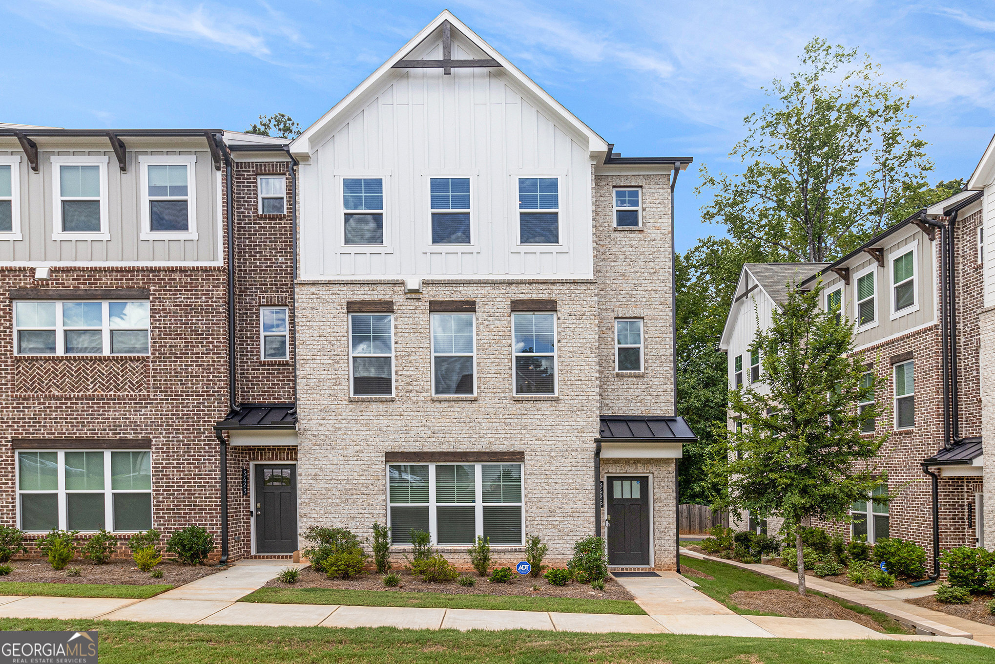 Stunning 3-Level End Unit in Avondale Park! Welcome to this beautifully designed townhome featuring custom upgrades and abundant natural light. The open main level boasts 9-ft ceilings, hardwood floors, and a chef's kitchen with a massive Valor White quartz island, herringbone tile backsplash, 42" white cabinets, and a spacious pantry. The dining area overlooks a lush courtyard, while the great room with a fireplace is ideal for cozy evenings or entertaining. Step out onto the private deck with tree-lined views-perfect for morning coffee or evening wine. Upstairs, enjoy dual sunlit primary suites: Primary #1 features a spa-like bath with white quartz double vanities, oversized tile shower, private water closet, and walk-in closet. Primary #2 includes a full en-suite bath and its own walk-in closet. The terrace level offers flexibility for a guest suite, home office, or teen/in-law retreat with its own full bath and private entry. Additional perks include a 2-car garage, EV charging outlet, and extra storage. Located near historic Avondale Estates and just 2 miles from vibrant Downtown Decatur shopping and dining!