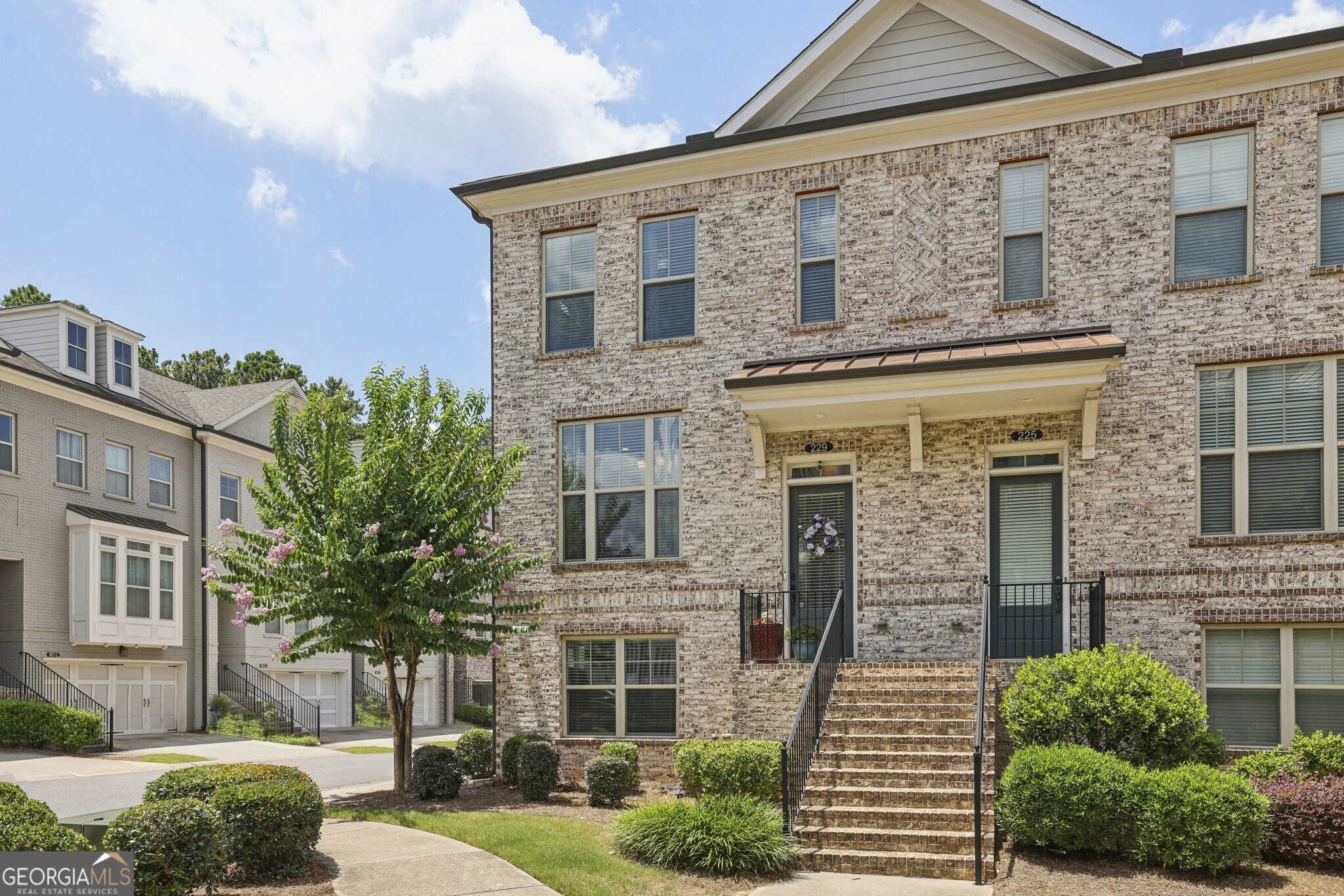 Rare End-Unit Gem in the Top-Ranked Northview High School District! Ideally located in the heart of Johns Creek recently named the #1 Place to Live in the U.S. this beautifully appointed townhome sits within a sought-after Gated Community offering unmatched convenience and lifestyle perks. Step inside to discover Soaring Ceilings, Gleaming Hardwood Floors, and Elegant Crown Molding throughout the main level. The Open-Concept Layout features a spacious Fireside Family Room with a striking Stone Fireplace and Wood-Beamed Mantel, plus a bright Flex Space perfect for a Home Office or Reading Nook. A Private Back Deck provides an ideal for morning coffee or evening wine. The Chef's Kitchen is a true showstopper, complete with Granite Countertops, Classic White Cabinetry, Subway Tile Backsplash, Stainless Steel Appliances, and an Oversized Island perfect for entertaining or everyday meals. A dedicated Dining Area connects seamlessly with the kitchen for easy flow and open sightlines. Upstairs, the Oversized Owner's Suite is a serene retreat with a Tray Ceiling, Massive Walk-In Closet, Dual Vanities, Glass-Framed Shower, and a Luxurious Soaking Tub. A spacious Secondary Bedroom with a Private En-Suite Bath provides the perfect setup for guests or family. The Laundry Room is conveniently located upstairs. The Finished Terrace Level adds incredible versatility with a Full Bedroom and Bathroom ideal for guests, a home gym, or a playroom. An Oversized Garage offers excellent storage, and the Back Deck delivers peaceful, private views. Enjoy Resort-Style Amenities including a Swimming Pool, Tennis Courts, Clubhouse, and Playground. The home is walking distance to Cauley Creek Park, a local gem featuring a 5K Paved Trail, activity lawns, and recreation areas for walking, biking, and enjoying the outdoors. Just steps from Publix, coffee shops, and restaurants with a brand-new, Avalon-style shopping and dining district under development nearby this location offers both immediate convenience and exciting future potential. Centrally located with easy access to Suwanee, Duluth, Alpharetta, and Cumming, this home is more than a place to live it's a lifestyle.