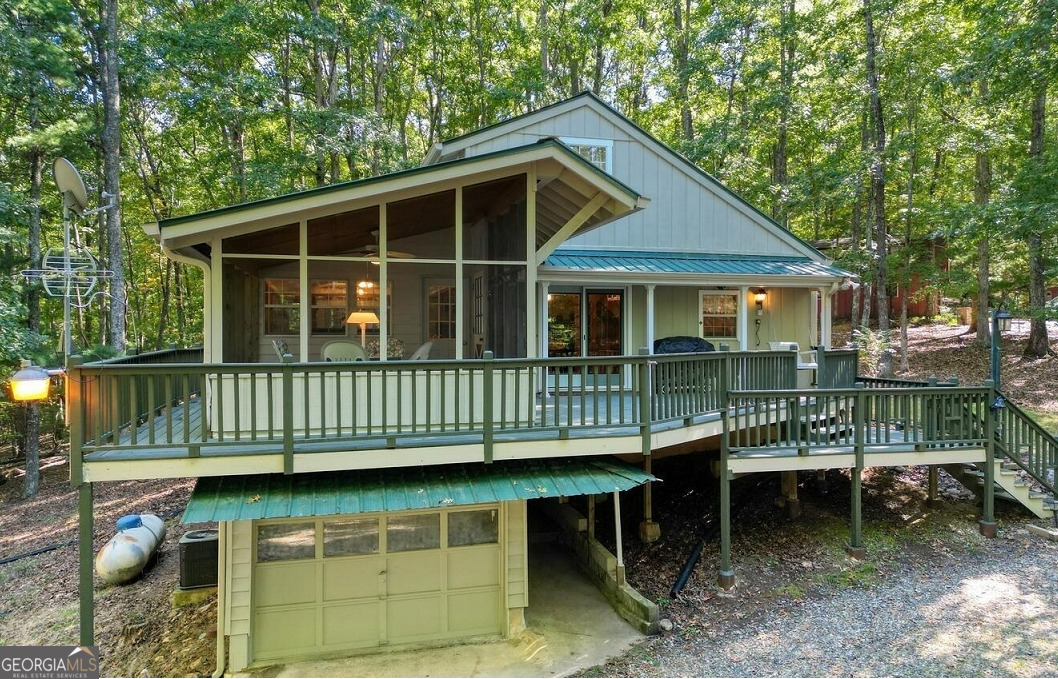 Cute Cabin 2 BR/1.5 BA, This is a great price for a home in North Ga mountain area of Blairsville. Check out this Charming cabin in the woods with over 2 acres located near Lake Nottely. Easy access to Hwy 515 between Blairsville and Blue Ridge. This home has a large open living area, nice screened porch and deck and a drive under unfinished basement. Beautiful wood floors, central heat and air and a wood stove in the living area. Bedrooms are upstairs with 1/2 Bath, Full Bath on Main. Also check out the 7 x 11 Pole Barn. Enjoy the privacy.
