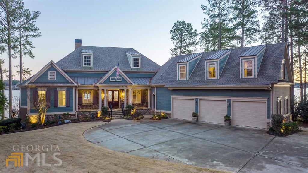 Owner is also the listing agent. Don't miss this Reynolds lakefront PREMIER LEVEL LOT luxury home with magnificent big water views from nearly every room in the house. You'll never have to miss the spectacular sunrises AND sunsets on beautiful Lake Oconee. Built by quality builder, Jim Joel, for his personal residence, this house offers extraordinary attention to detail featuring high coffered ceilings, large arched windows framing the breathtaking lake views. Stunning trim and extensive millwork throughout along with an open floor plan makes this house ideal for entertaining. Enjoy morning coffee on the screened in porch or in the breakfast nook surrounded by windows. The kitchen boasts a large island, custom built cabinetry with luxury brand appliances for any gourmet chef. The master suite overlooks the lake along with a spacious bath suite and closets. The terrace level includes family room, guest suites, and a beverage center opening up to a pool, jacuzzi, fire pit and max dock. This property is a rare gem. Select furniture and boat are available under separate agreement. Seller is making membership available.