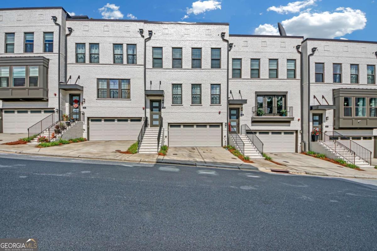 THE BEST OF THE BEST.... This four level elegantly appointed townhome with the finest finishes including surround sound. Main level with gourmet kitchen, oversized island and stainless steel appliances. Large living area plus breakfast area or home office plus powder room. Owner's primary suite features two walk-in closets and luxurious bath. Two additional well appointed bedrooms and full bath. The private rooftop is unmatched with skyline views of City of Atlanta and Buckhead with additional bath is ideal for home office. The lower level features a media room with full bath that may be used as a 4th bedroom.