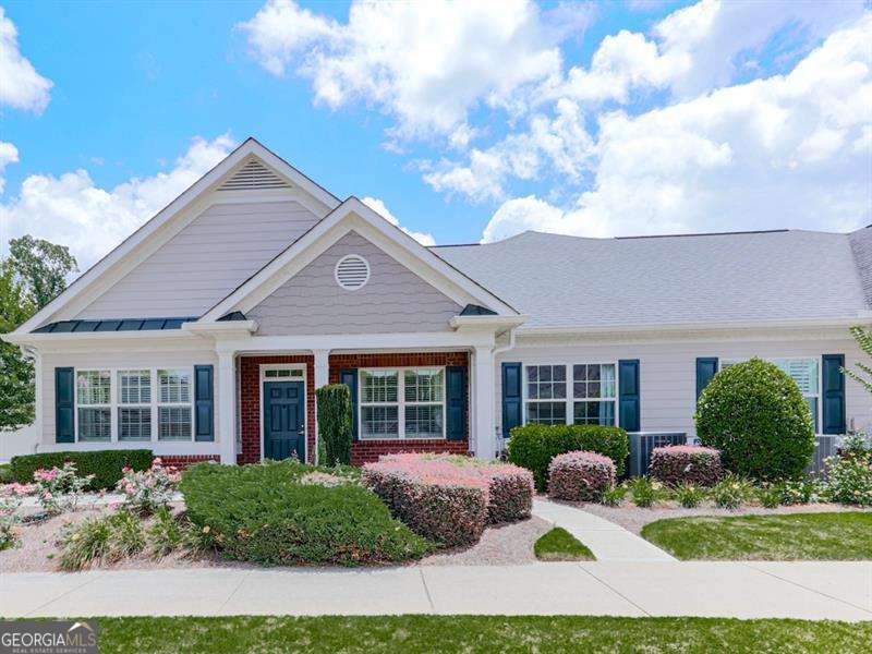 Welcome to the highly sought after, Orchards of East Cherokee! Discover easy, one-level living in this warm and inviting 2-bedroom, 2-bathroom home in the heart of Hickory Flat. Located minutes from downtown Canton, Woodstock, and Northside Cherokee Hospital, this friendly and active community offers the perfect blend of convenience and comfort. This spacious home features an open floor plan with a large living area, a separate dining room ideal for entertaining, and a bright flex space with two walls of windows-perfect for a sunroom, reading nook, or hobby room. The oversized primary suite offers a generous walk-in closet and a large bathroom, while the guest bedroom and bath provide privacy and comfort for visitors. Enjoy added bonuses like a full-sized laundry room equipped with a washer and dryer, a 2-car garage with permeant stairs to ample storage space above. This home also provides low maintenance living with lawn care handled for you. A short walk across the street to the community center offers wonderful amenities including a pool, and walking paths, with regular gatherings and events that make it easy to connect with neighbors. Don't miss your chance to enjoy a vibrant lifestyle in one of Hickory Flat's most desirable 55+ communities-The Orchards of East Cherokee!
