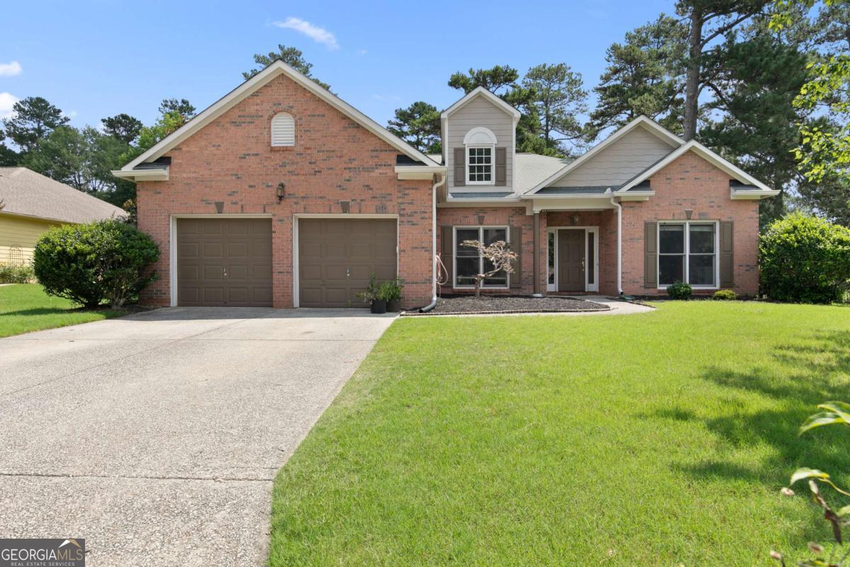 Welcome to your dream home in the sought-after Mirror Lake golf community in beautiful Villa Rica, Georgia. This stunning brick face ranch offers both elegance and comfort with sweeping golf course views, soaring ceilings, and a well-appointed layout designed for easy living and entertaining. Step through the arched entry and take in the grandeur of cathedral ceilings and abundant natural light. A formal living room and dining room flank the foyer, featuring tray ceilings, over 10-foot heights, and graceful architectural details. The open-concept kitchen boasts stainless steel appliances, solid surface countertops, tall cabinetry, and a walk-in pantry, opening to a large dining area and spacious fireside family room anchored by oversized windows and views of the course. The primary suite on the main level is a peaceful retreat, complete with double tray ceilings, golf views, and a luxurious bath featuring dual vanities, a soaking tub, and generous closet space. Two additional bedrooms share a large bath with double vanities, and each offers walk-in closets and plush carpeting. Additional highlights include: Hardwood floors throughout main areas Oversized powder room for guests Large laundry room with utility sink 2-car garage Covered patio and paver walkway leading to an expansive deck perfect for outdoor dining or simply soaking in the serene golf course setting With resort-style amenities and an unbeatable lifestyle, this home delivers the best of Mirror Lake living; comfort, community, and championship golf at your doorstep.