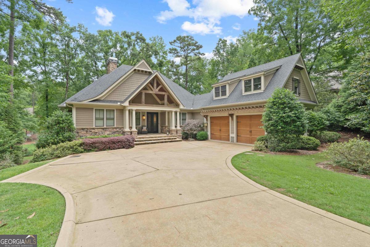 Discover elevated golf living in this exquisite golf home nestled on the prestigious Preserve Course #8, offering breathtaking views of the serene pond and the lush #7 green. This meticulously designed residence boasts 3 spacious bedrooms and 3.5 beautifully appointed bathrooms, perfect for those seeking a harmonious blend of elegance and comfort. Step inside to a welcoming open floor plan that seamlessly connects the living spaces, creating an inviting atmosphere for both relaxation and entertainment. The owner's suite is a private oasis, featuring a tray ceiling and a cozy sitting room with expansive golf course views. Enjoy direct access to the screened porch, where you can unwind in tranquility. The ensuite bathroom offers a garden tub, dual vanities, and ample space for a spa-like experience. The living room is a masterpiece of sophistication, adorned with gleaming hardwood floors, a striking stacked stone fireplace, and custom built-ins. Sliding doors open to the screened porch, allowing for seamless indoor-outdoor living and captivating views of the verdant landscape. A chef's kitchen expands the living space with large island with bar for dining, breakfast room, striking custom cabinetry, stainless appliances and a gas range. The terrace level is designed for leisure and entertainment, featuring hardwood floors, a stylish bar area, and a great room complete with a fireplace and porch access. This level also includes two additional bedrooms, two bathrooms, and versatile flex space that can serve as an extra bedroom, gym, artists studio or storage area. As an added bonus, the seller is offering a coveted golf membership, making this home an irresistible opportunity for golf enthusiasts. Immerse yourself in the unparalleled lifestyle of Reynolds Lake Oconee, where luxury meets nature in perfect harmony. Don't miss the chance to make this extraordinary property your own.