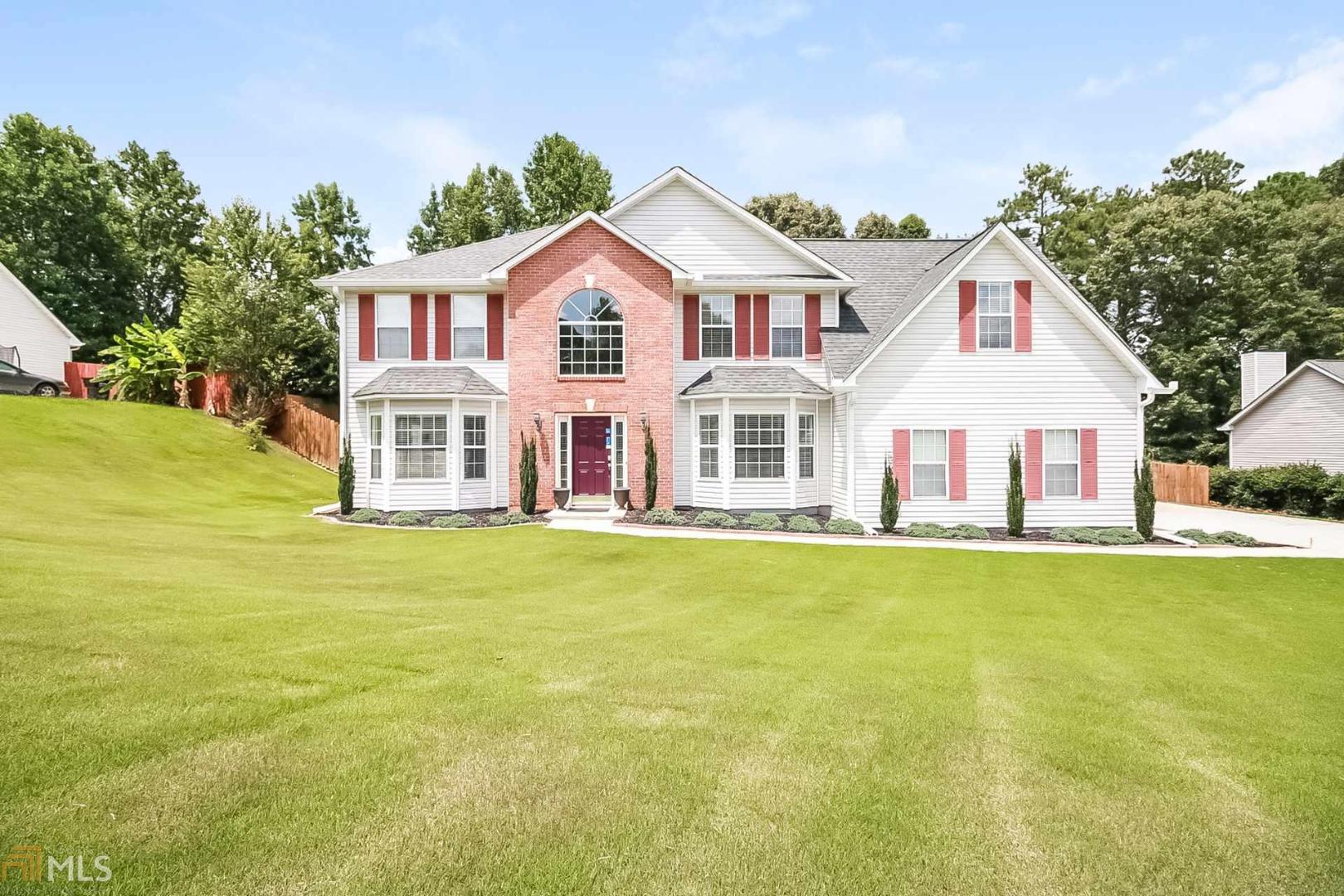 This Douglasville two-story cul-de-sac home offers two fireplaces, a den, and a two-car garage. Home comes with a 30-day buyback guarantee. Terms and conditions apply.