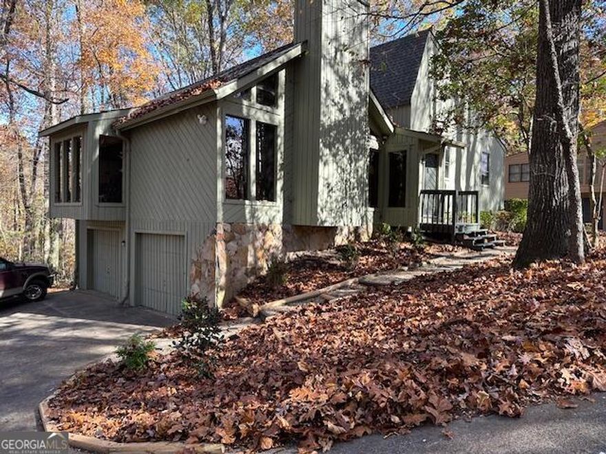 Welcome to this charming beautifully maintained home located on a 3/4 acre wooded lot. You'll find a spacious 4 level layout featuring 5 bedrooms and 3 full bathrooms plus a new separate walk in porcelain shower in the main master BR. The second level features 2 master size bedrooms and a large updated bath with jacuzzi tub and walk in closet. On the 3rd level you find a large living area with a floor to ceiling stone wood burning fireplace, vaulted ceiling and large windows. This leads to the dining room and the well appointed kitchen and breakfast nook. The house features 2 raised decks and a large 2 car garage. Location is 1 mile from the high school, grocery and restaurants, and 1/4 mile from the elementary school. 5 mins to I-75.