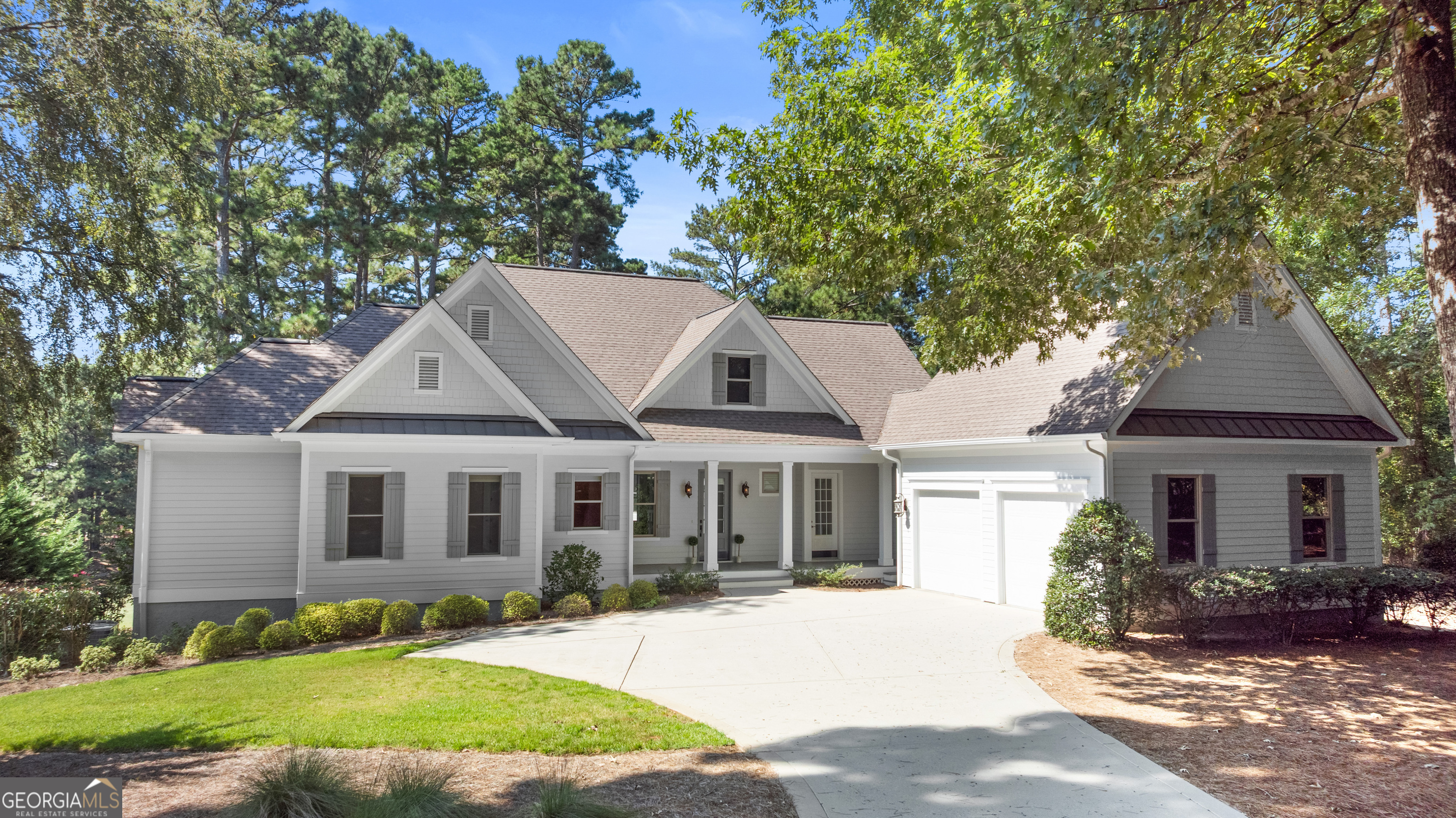 Welcome to this beautifully updated home with stunning views of the 6th fairway of the Reynolds Landing golf course as well as seasonal lake views. Featuring 4 ensuite bedrooms, including two conveniently located on the main level, this welcoming retreat offers comfort and flexibility for family and guests. The main family room is anchored by a stunning wood-burning fireplace, while the downstairs den includes gas logs, creating multiple inviting gathering spaces year-round. Step outside to your fire pit and take in the sweeping views of the 6th fairway, perfect for entertaining or relaxing evenings. The remodeled kitchen is equipped with stainless steel appliances, and the home has been refreshed inside and out with new paint. New HVAC units, a new hot water heater, refurbished lawn irrigation system, and an RF Designs security system will provide peace of mind for years to come. Seller is making a cub membership available, which offers access to the world class amenities of Reynolds including golf, tennis, fitness, dining, and much more! Thoughtfully updated and move-in ready, 1011 Ridge Terrace combines charm, convenience, and stunning views-an ideal place to call home.