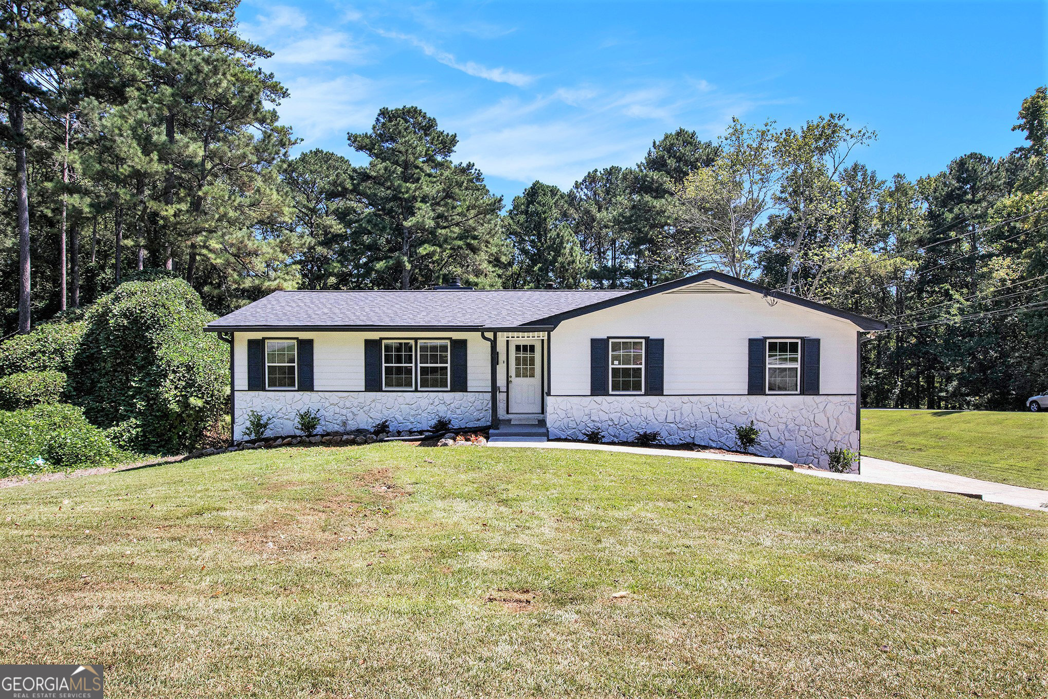 Welcome to this stunning,cozy residence located minutes from 78 Hwy for your convenience! This home is updated with new flooring and carpet throughout, fresh paint throughout, and new roofing. The kitchen is complete with stainless steel appliances, white cabinetry, and new quartz countertops with a breakfast area and separate formal dining space. Adjacently, the family room is complete with a fireplace to warm up after a long day and leads to a new deck outside, overlooking a spacious, lush, level backyard. The master bedroom is located on the main floor and neighbors the updated bathroom, complete with modern tiles and a new quartz countertop on the vanity. There are two additional bedrooms on the main level with an additional bathroom with a new countertop and shower-tub combo. The New garage Doors leads into the basement with additional space which has also been freshly painted. This residence is in an Brookwood school district and is not one that should be passed up! This home is a must-see to be appreciated! NO HOA or Rental Restrictions