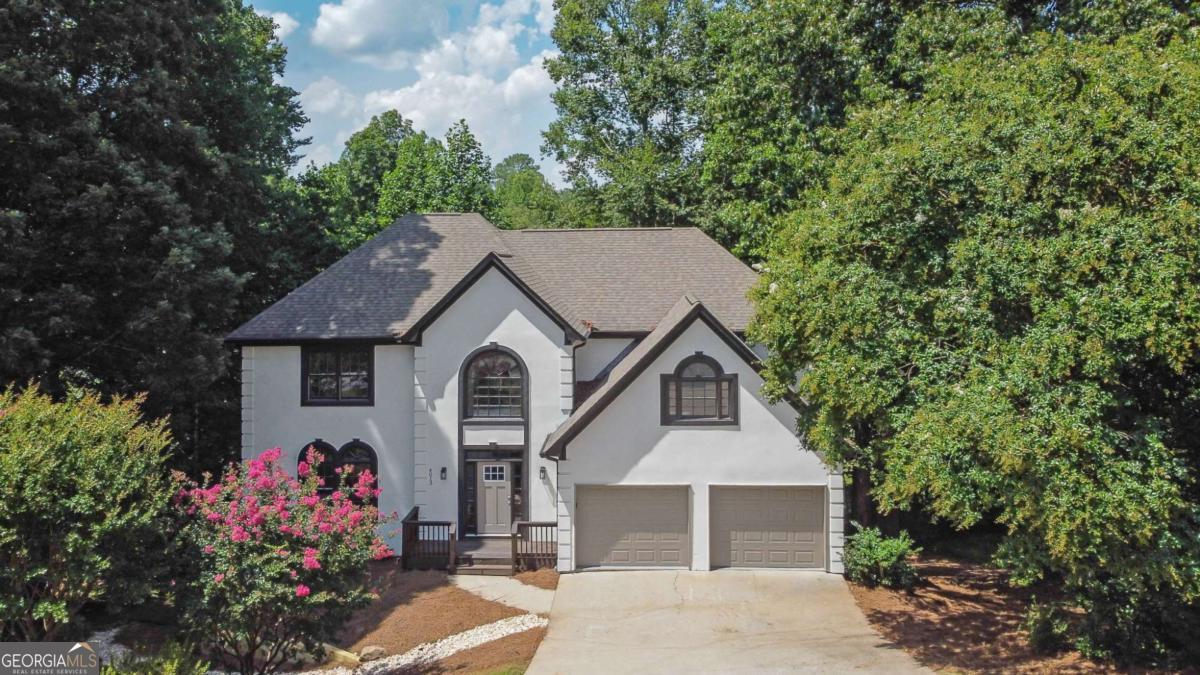 Check out this beautifully renovated traditional home in the Lexington neighborhood-offering tons of space, designer touches, and move-in-ready finishes! Step inside to a gorgeous two-story foyer with light oak hardwoods, flowing into open living and dining spaces filled with natural light. The remodeled kitchen stuns with white cabinets, sleek stainless appliances, quartz countertops, and a cozy breakfast room overlooking the wooded backyard. The large family room with black brick & shiplap fireplace opens to an oversized party deck-perfect for gatherings and relaxing evenings. Upstairs, the primary suite is a true retreat with a spa-like bath featuring a soaking tub, double vanities, walk-in shower, and a spacious closet. Three additional bedrooms, a large hall bath, and upstairs laundry complete the upper level. Enjoy the unfinished basement for future expansion, low-maintenance backyard, and updates including new HVAC, fresh paint, new lighting, new carpet, and a young roof. Minutes from shopping, dining, and top-rated schools in Marietta-this is the one you've been waiting for!