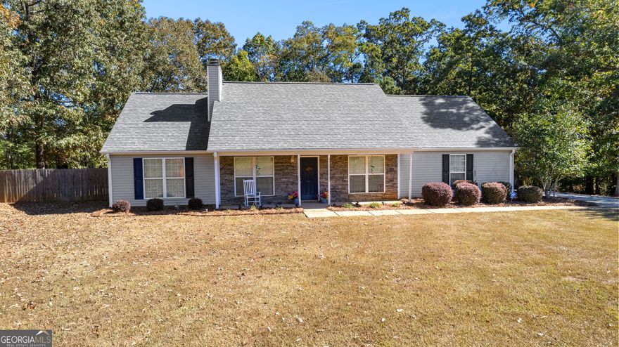 Be prepared to fall in love! You will not believe what this adorable, 3 bedroom 2 full bath, ranch home offers in tons of upgrades and improvements through out. ROOF, HVAC, WATER HEATER, LVP FLOORING, QUARTZ COUNTERS, NEW FIXTURES THROUGHOUT-- ALL LESS THAN 3 1/2 YEARS OLD!!  With over 2100 sq feet of living space, and situated on a impressive 1 acre lot with fenced, private backyard you will be proud to call this home. Entering from the rocking chair porch, you are greeted with neutral, calm colors, high vaulted ceilings and the gorgeous updated fireplace with the remote controlled heat and flame options.  Enjoy family dinners in the adjacent dining area and newly appointed kitchen with the new quartz counters, farmhouse style sink and stone backsplash. The spacious owner's suite is a true retreat! Behind the charming sliding barn door transport yourself with a spa like experience in the en suite bath.  Completely remodeled and updated, it will tempt you with lazy soaks in the free standing tub and long showers under the rainfall showerhead.  From the sleek tile, new cabinets, counters, new commode, to the anti-fog and touch light mirrors you will feel truly pampered. The secondary bath has new cabinetry, commode, and fixtures as well and is shared between the 2 spacious secondary bedrooms.  The charm continues outdoors with a spacious patio area ideal for relaxing or hosting gatherings. The fenced-in backyard offers privacy and plenty of space for pets or play. Soak up the tranquil peace of country living in the OLA area and still enjoy all that Henry county has to offer.  Schedule your private showing today!