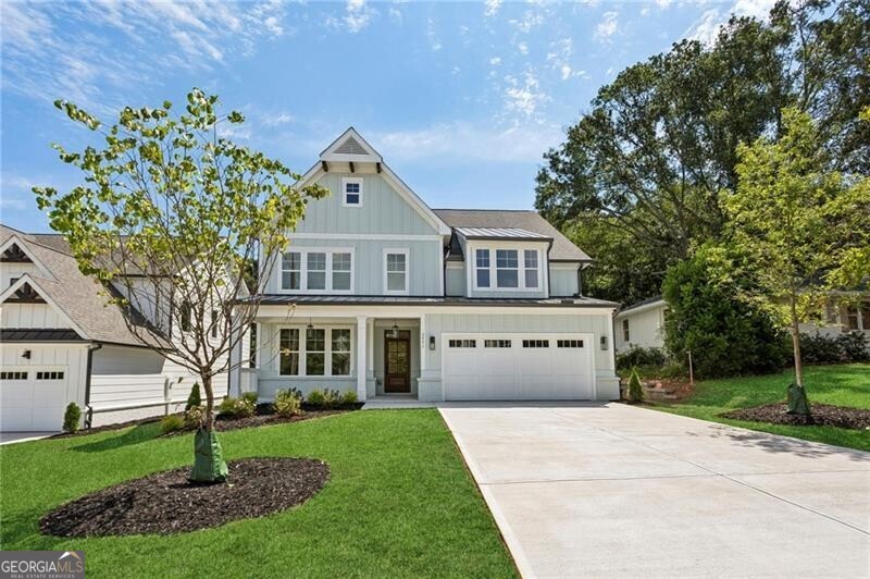 New Construction next to popular Williams Park! So convenient to the Smyrna Market Village and the Battery! This impressive modern farmhouse/craftsman-style home features a gorgeous stained wood front door, a 4-sides brick water table with a board-and-batten front, covered front and rear porches, and a HUGE professionally landscaped yard. The interior offers a dining room with a coffered ceiling, a study/den with beamed ceiling, built-in bookcases on both sides of the brick fireplace, lovely white oak site-finished hardwood floors, an open kitchen with high-end quartz countertops, stainless steel appliances, and a large island opening to the large family room. Upstairs, you'll find a lovely master suite with his/hers closets and a sitting area, as well as three spacious BR's - one w/ it's own ensuite bath. This one is a winner for sure!