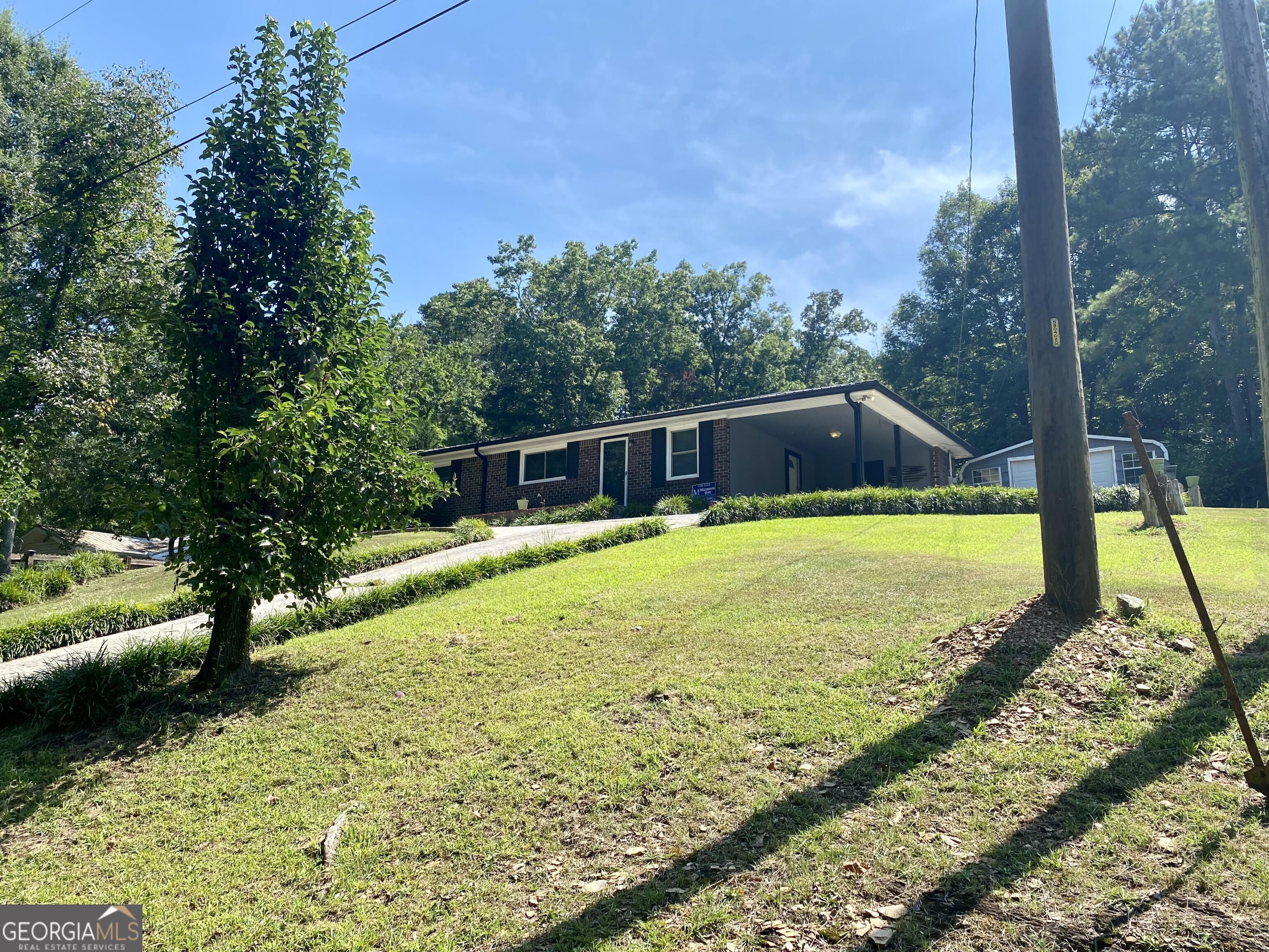CHARMING BRICK RANCH ON QUIET DEAD-END STREET Don't miss this well maintained brick ranch- located just one mile from W.L. Swain Elementary School and a short drive to Calhoun, Rome and Adairsville. Set on a dead end street this home offers a quiet setting with mature trees and a large backyard- perfect for families, entertaining or simply enjoying the outdoors. Step outside to your own retreat, complete with a patio area, fire pit, above ground pool and spacious deck-ideal for relaxing or hosting guest. Inside, the home features original hardwood floors, blending timeless character with modern updates. Recent improvements include new vinyl windows, new counter tops and backsplash, a new roof and gutters, HVAC system, and a new concrete walkway leading to the front door. Two oversized outbuildings- both with power- provide excellent space for storage, a workshop or hobby use. Whether you're a first-time buyer or looking to downsize, this home offers comfort, convenience and charm in a quiet, established neighborhood.