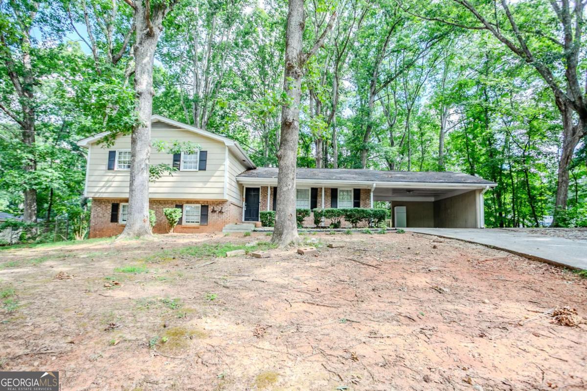 Nestled on a generous lot, this split-level home presents a versatile layout with room to grow. Multiple living areas across two levels offer flexibility for gathering, entertaining, or creating a dedicated office or guest suite. The separate dining area, spacious kitchen, and cozy den provide a practical and functional flow. A covered carport and private backyard add convenience and outdoor potential. Whether you're looking for a home to personalize or an investment opportunity, this property delivers space and value in a well-situated location.