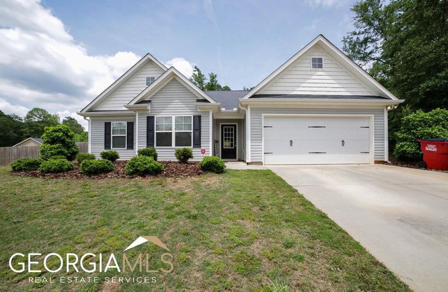 Hosted in Banks County's premier community, Hebron Place, is a pristine, like-new craftsman that's ready to show you what it's all about. Just a few years young, built in 2019, this easy-living ranch boasts an open concept highlighted with upgraded finishes presenting key elements that create this compelling home. Crafted with an ever-desirable, single-level living concept , this gracious plan hosts a welcoming foyer that effortlessly transitions to the great room where the exciting details come alive. Durable luxury vinyl plank flooring, fireplace, decorative light fixtures, designer's choice paint palette, double paned windows accompanied by 2in. blinds, and 9 ft. ceilings are just a few of the standout features that adorn this home. The spacious design maximizes every inch of usable space, and creates the perfect backdrop for entertaining. With the great room being completely open to the kitchen, the home chef will never have an issue overseeing their guest. Featuring striking appointments and providing ample space, whipping up gourmet cuisine will be a breeze. This sparkling kitchen is equipped with an abundance of custom stained cabinets, sleek granite counter tops that extend to the oversized island, large pantry with shelving system, and a spacious breakfast bar that offers extra seating. The kitchen also lends space to the sunroom-styled dining room perfect for enjoying your morning cup of coffee as you take in the territorial views of the private rear yard. Comprised of a split-bedroom configuration places the owners retreat just off the great room, with two accessory bedrooms and a perfectly detailed full bath spanning the front of the home. To your delight, the owner's suite is upgraded with all the expected accoutrements such as space for large furniture, lofty tray ceilings, plush carpet flooring, spacious closet with shelving system and a full bath. Well appointed, the ensuite bath was enhanced with an granite, dual-sink vanity, separate shower, and garden tub encouraging relaxation. With Summer right around the corner, enjoy a little time outdoors or hosting BBQs on the open-air patio overlooking the privacy-fenced rear yard. All of these dynamic features are perfectly enveloped on an expansive 1.01 acre corner lot, adorned with professional landscaping adding to its curb appeal. Last, but certainly not least, this homes desirable location places it within 8 miles to Banks Crossing, Tanger Outlets shopping and I-85. If you're searching for a well-kept, newer home boasting upgraded appointments, then 105 Meadow Creek Court is calling you home!