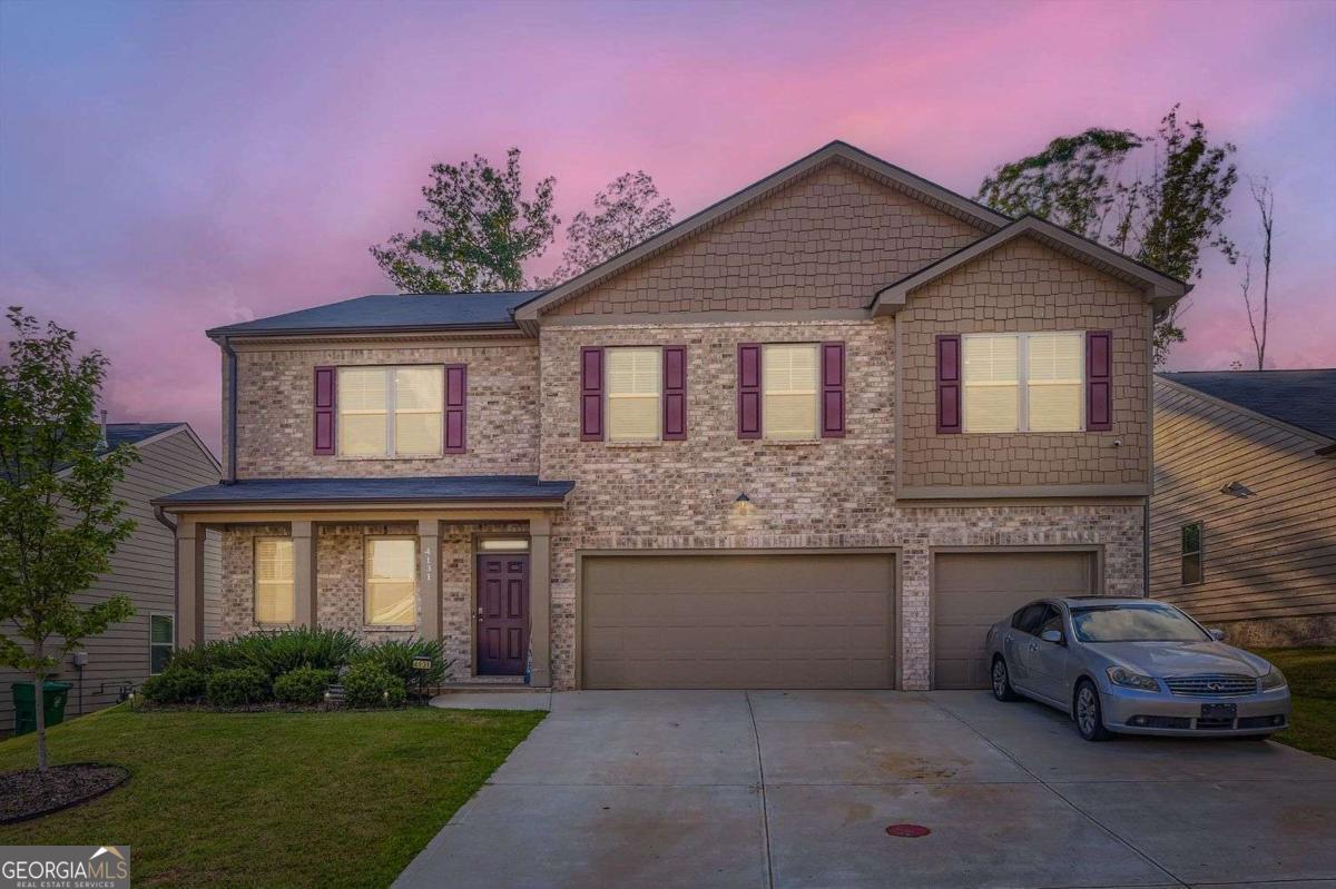 Absolutely beautiful two-story home nestled in the Enclave at Flat Rock Hills Community. Offering spacious living with 5 bedrooms and 5 bathrooms. The main level features a versatile formal living and dining area, currently used as a game room, alongside a cozy family room with a fireplace and an open view to the eat-in kitchen. The kitchen boasts an island and a pantry, perfect for meal prep and storage. Also on the main floor is a bedroom, a full bathroom, and a convenient half bath. Upstairs, you'll find a loft that can be used as an additional living room, den, office area or ideal for an entertainment space. Three additional bedrooms, including a luxurious primary ensuite with dual sinks, a separate tub and shower, and a large walk-in closet. Enjoy outdoor living on the covered patio overlooking the fenced backyard-ideal for relaxing or entertaining. The community enhances your lifestyle with amenities including a pool, playground, tennis courts, and more. Conveniently located just minutes from I-20, Arabia Mountain Nature Preserve, Stone Mountain Park, Brownsmill Park, Biking and Walking Trails and Stonecrest Mall. Don't miss the opportunity to make this well-appointed home yours! Discounted rate options and no lender fee future refinancing may be available for qualified buyers of this home.
