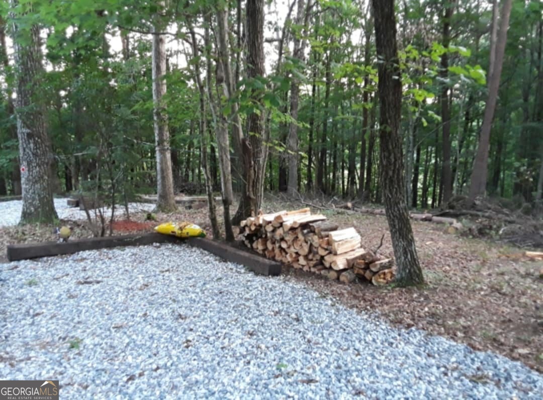 This serene 0.94 acre partially cleared lot offers stunning mountain views and a peaceful setting that's ready for your dream home or for your very own rental cabin! Gravel driveway already in place and gravel spread across the site, power access and community perks like a pool, water, trash service included! A minimum of 650 sq ft home, but no tiny homes, modular, mobile homes, or container homes are allowed. Your vision for a custom mountain retreat can come to life here. Adventure and relaxation await just minutes away from the thrills of a Georgia Mountain Coaster to the charm of the Uhuburg Renaissance Castle. Spend days tubing in Helen, hiking Mt. Yonah or Dukes and Anna Ruby Falls, exploring the gold mines of Dahlonega, or sipping wine at nearby vineyards. And don't forget the magic of Babyland General Hospital! Don't miss this opportunity, schedule a showing with your favorite agent.
