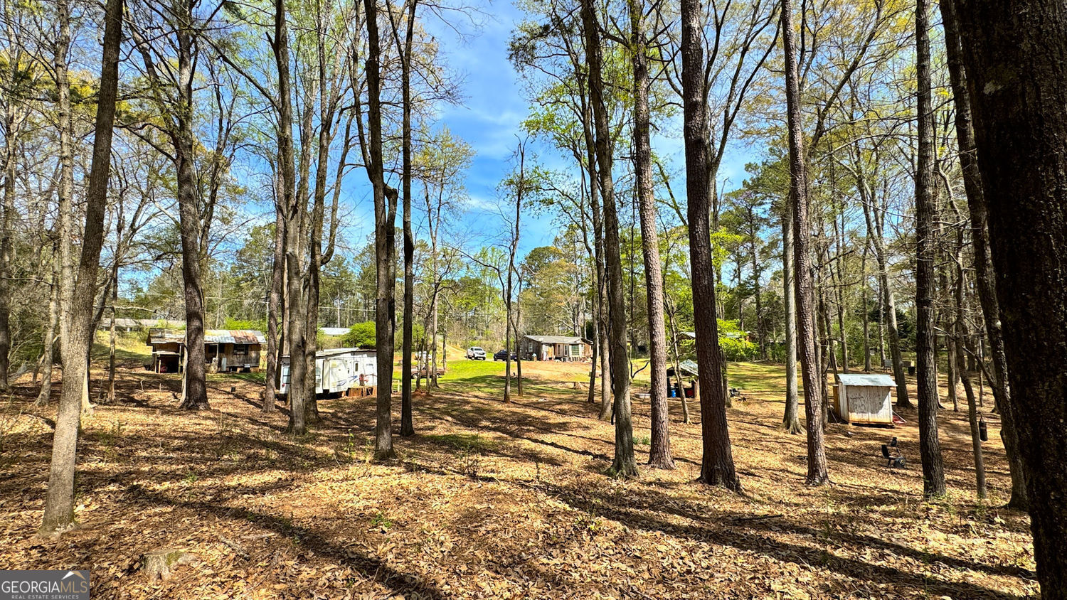 Endless Potential on 4 Acres in LaGrange, GA! This unique 4-acre property offers a rare opportunity with two homes, a shed, and a camper (which can stay or go), all surrounded by beautiful hardwood trees. Whether you're looking for a multi-generational living setup, rental income potential, or a prime investment opportunity, this property is full of possibilities. Both homes are in need of rehab, allowing you to customize and add value. The land consists of two separate tracts, currently combined for tax purposes but easily dividable if desired. (two addresses, two septic systems, two water meters, two electrical hookups). Conveniently located just minutes from the Kia plant and West Point Lake, this property offers the perfect blend of privacy and accessibility. Opportunities like this don't come around often-bring your vision and make it yours! Sold as-is.