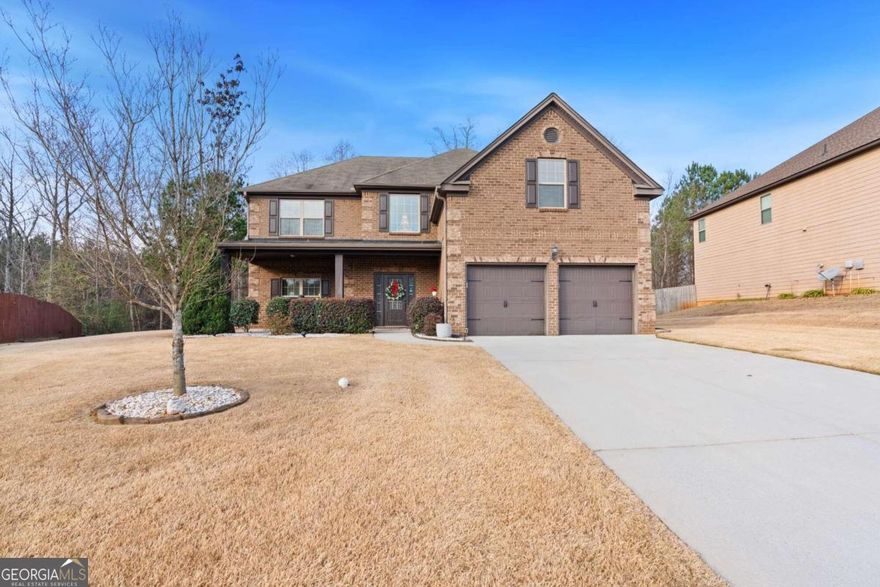 Welcome home to this beautiful 4 bedroom brick front home in Douglasville! The front porch leads you right inside to a two story foyer with gorgeous hardwood floors throughout the main level. The dining room with coffered ceilings is perfect for formal gatherings. The fireside family room is a great spot for relaxing, family time, or movie time or sports viewing time. The kitchen boasts double ovens, a large island and plenty of counter space for food preparation and entertaining. The breakfast nook is a perfect spot for a quick snack or any meal. The covered back porch is off the family room and it is just the spot for morning coffee or an anytime beverage and chill out space while enjoying the private backyard. There is a half bath on the main level as well. Upstairs you find the large owner's suite and en suite bathroom with dual vanities, a separate shower, and a large tub. Three additional bedrooms and a full bath complete the upper level. The gated community entrance provides an additional sense of security. Super high speed fiber internet is available, and it's reasonably priced.