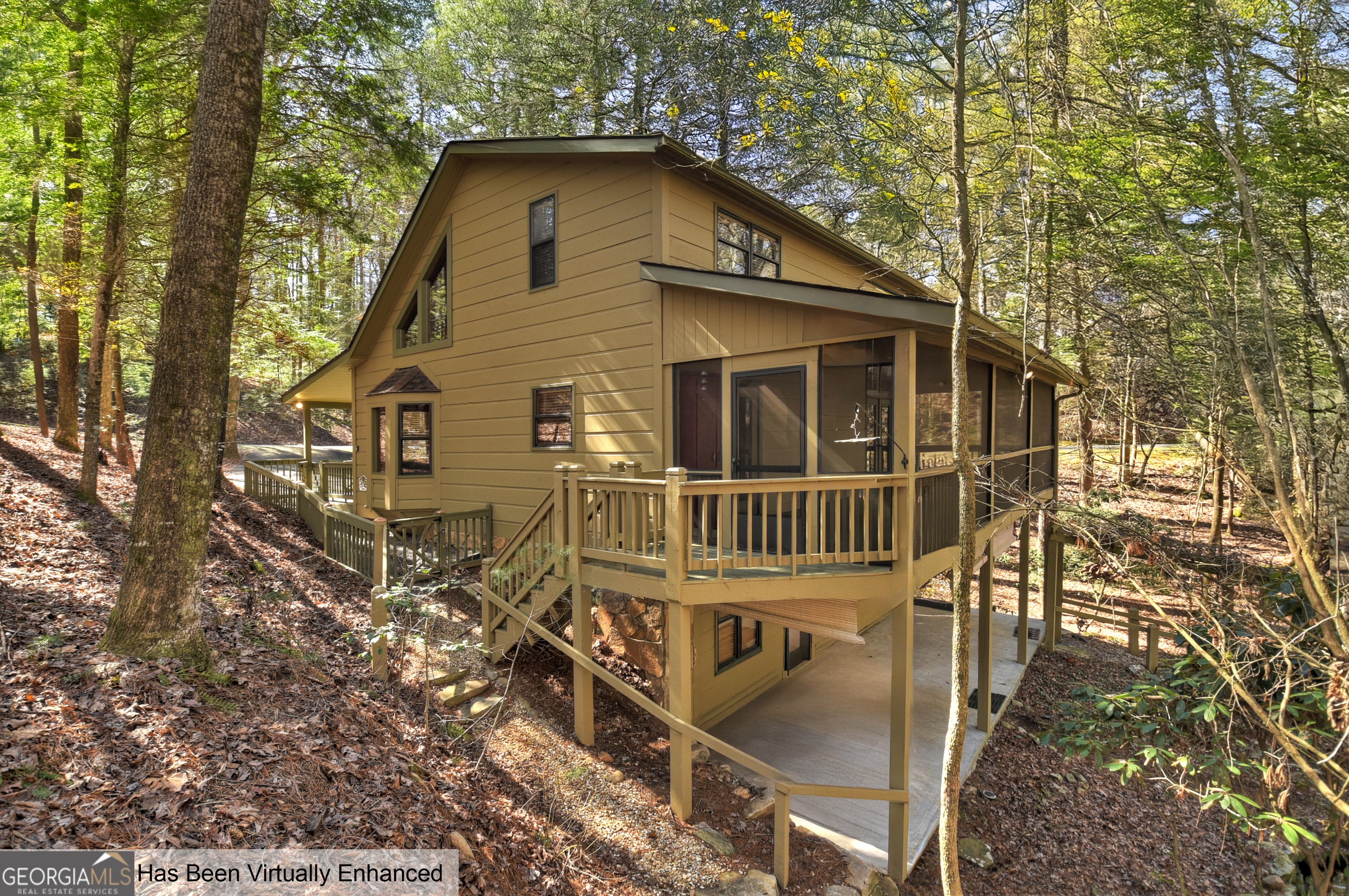 BACK ON MARKET at no fault of the Seller. Escape to the serenity of Goose Island Hideaway with this 3-bedroom, 3-bath mountain cabin nestled in a picturesque wooded setting. Whether you're seeking a full-time residence or a vacation retreat, this home offers the perfect blend of rustic charm and modern convenience. The great room welcomes you with a cozy gas log fireplace, soaring ceilings, and a dining area with a charming window seat. The kitchen features stainless steel appliances, including a Bosch wall oven and Bosch dishwasher, along with granite countertops. Enjoy bedrooms and baths on all three levels, providing privacy and space for guests (primary bedroom on main floor). The upstairs suite boasts a spacious bedroom, full bath, and a large loft-ideal for extra sleeping (loft has a closet so it works for a bedroom as well). The finished basement offers incredible versatility, with an oversized home office featuring walls of built-in cabinets and shelves, plus an additional large room with a small gas fireplace, perfect as a bedroom or hobby space. Outdoor living consists of a screened porch and a lower-level patio and a peaceful waterfall feature. A detached garage with a workshop area provides extra storage and workspace, while the whole-house generator ensures comfort in any season. Easy access with front and rear driveways. Located in a nature sanctuary, Goose Island Hideaway, gated community with a charming covered bridge entry and all paved roads, this home sits perfectly between Blue Ridge and Ellijay, offering easy access to both beloved mountain towns. Plus, full-time residents aged 65 and older receive a tax credit with no school tax. Don't miss this rare opportunity to own a beautiful mountain retreat in an ideal location! (Short term rentals are allowed; however, this home has never been a rental.)