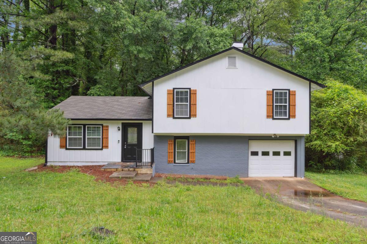 Welcome home to this beautifully renovated, move-in-ready gem located just minutes from I-20, downtown Atlanta, and top-tier shopping and dining. Step inside to a light-filled living room featuring new and durable LVP flooring-perfect for both everyday living and entertaining. Just around the corner, a dedicated dining area sets the scene for intimate dinners and lively gatherings. The open-concept kitchen is a standout with new cabinets, gleaming granite countertops, and plenty of storage and prep space-ideal for the home chef. Adjacent to the kitchen, enjoy a cozy sunken family room complete with a wood-burning fireplace, creating the perfect setting for relaxing evenings or movie nights. Step out back to a spacious patio that overlooks a private backyard-an excellent space for grilling, entertaining guests, or simply enjoying quiet mornings with a cup of coffee. Upstairs, the primary suite offers comfort and functionality with an updated vanity, tile-accented bathroom, and ample closet space. Two additional bedrooms provide flexibility for guests, family, or a home office setup. Additional features include a 1-car garage with extra storage space, making this home as practical as it is charming.